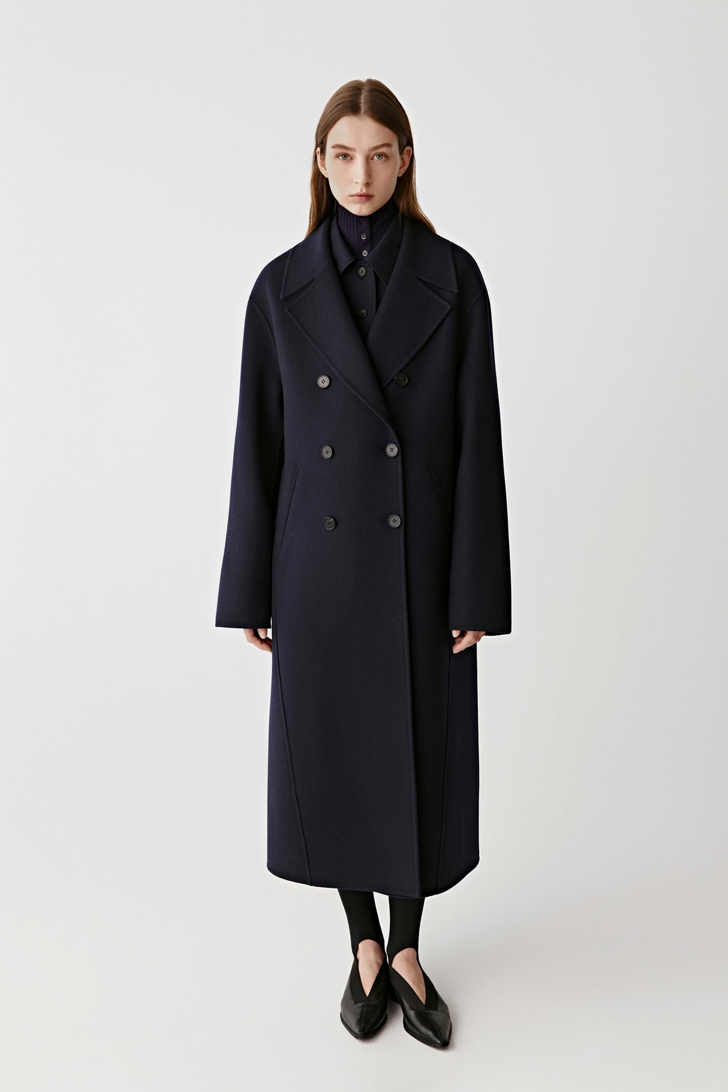 Three-quarter front view emphasizing the tailored silhouette and welt pockets.