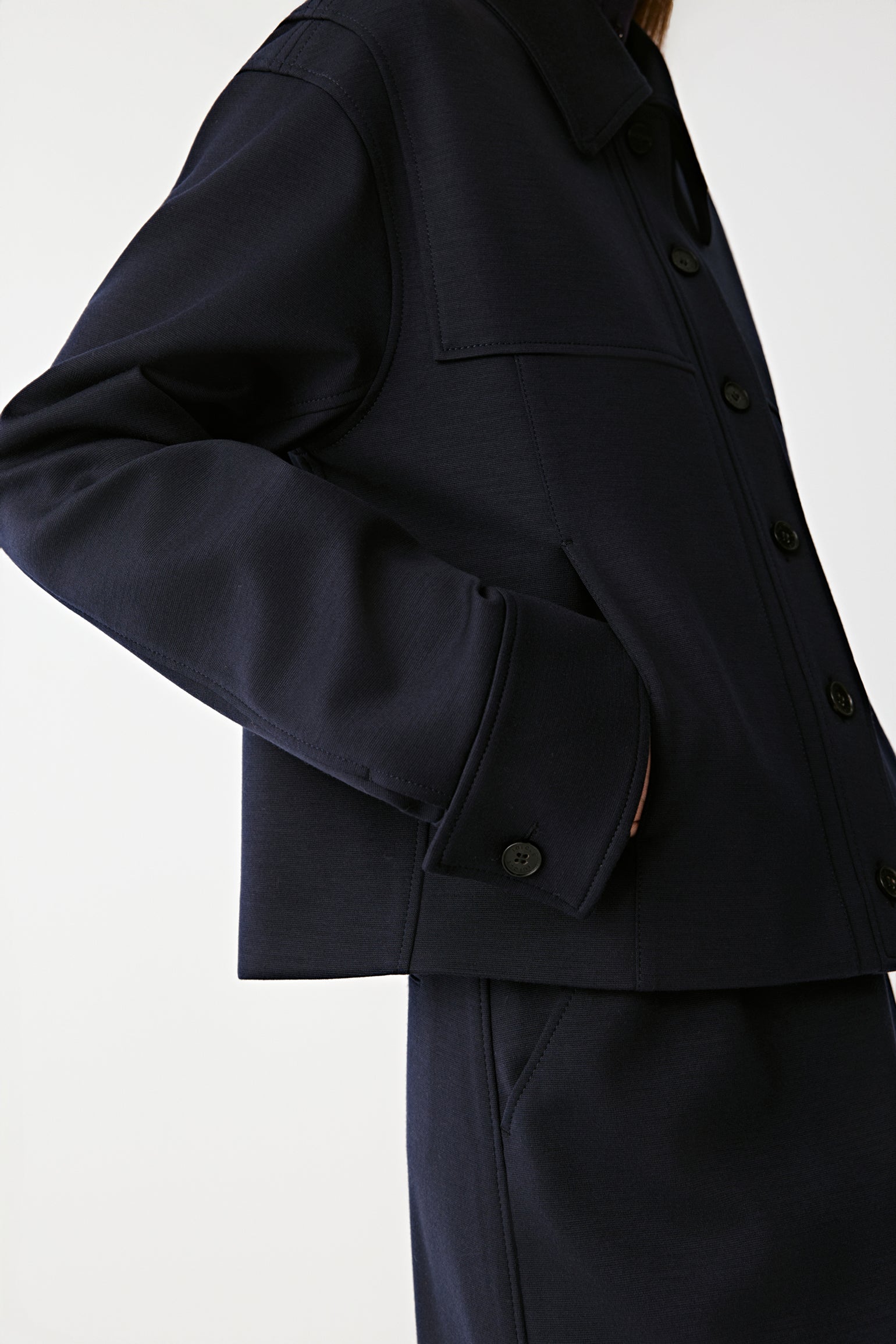 Close-up of the buttons and pocket detail showing the jacket’s refined texture and craftsmanship.