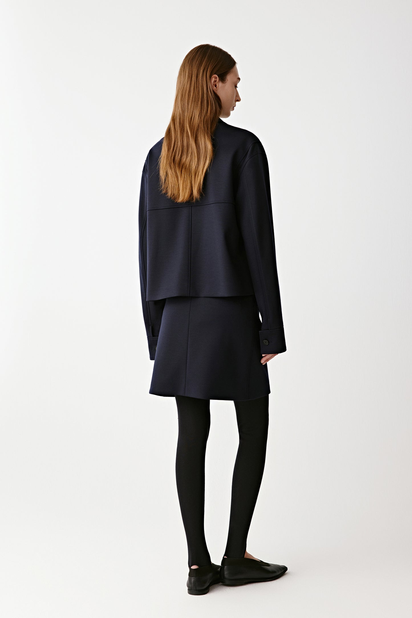 Back view revealing the belt’s knot and clean seam lines for a tailored finish.