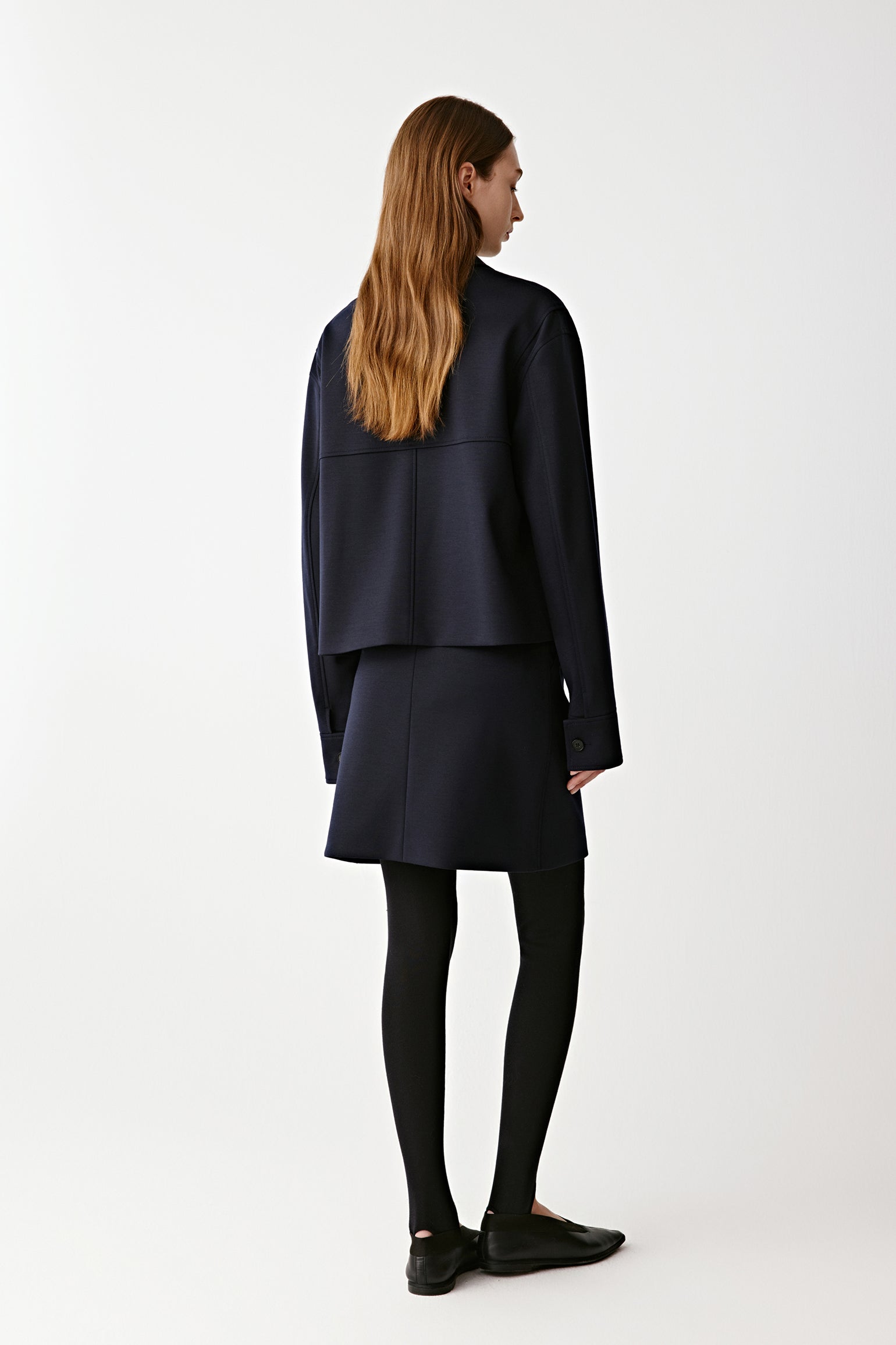 Back view revealing the belt’s knot and clean seam lines for a tailored finish.