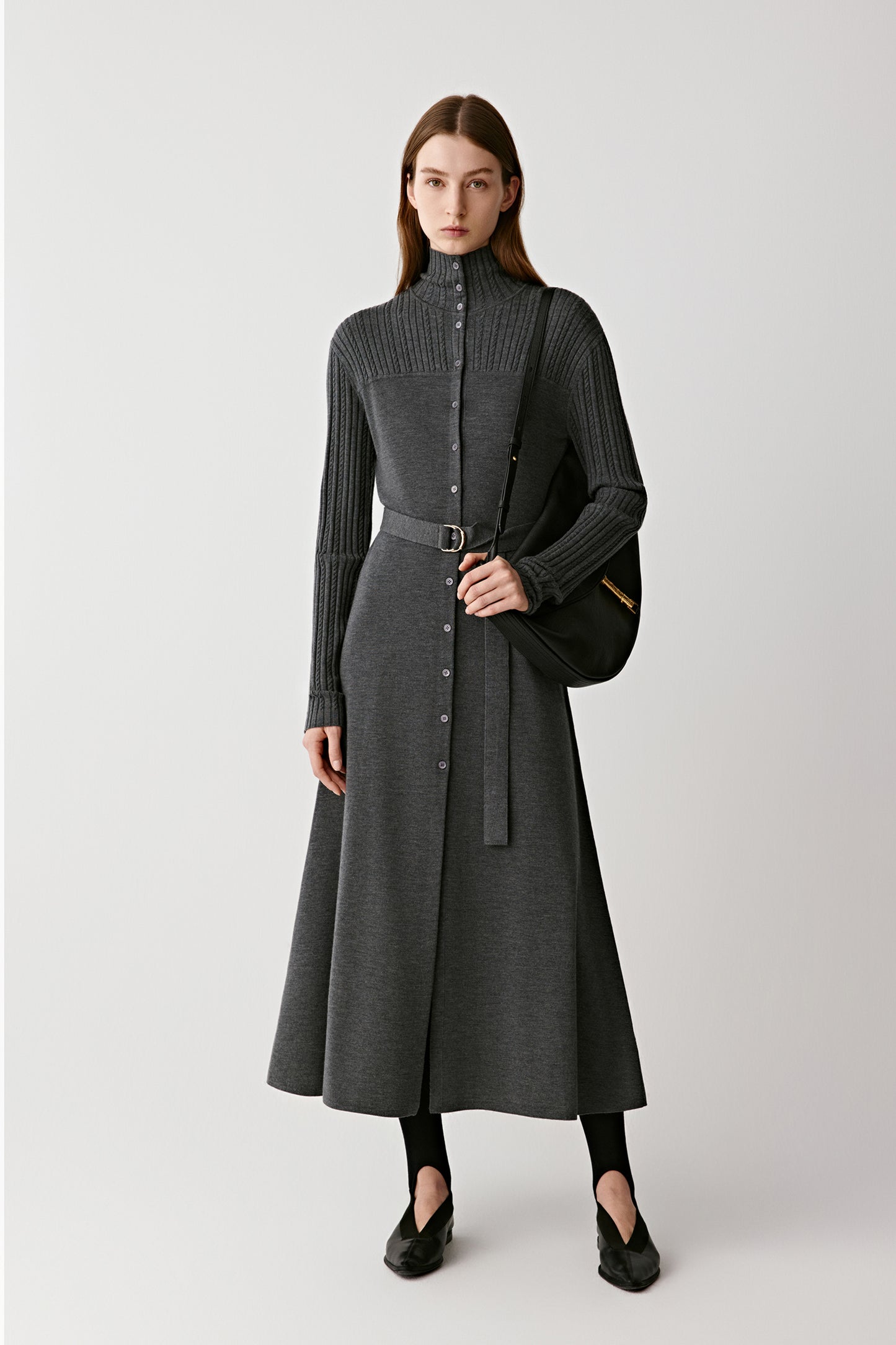 Front view of a model wearing a grey worsted wool midi dress with long sleeves and a fitted waist.