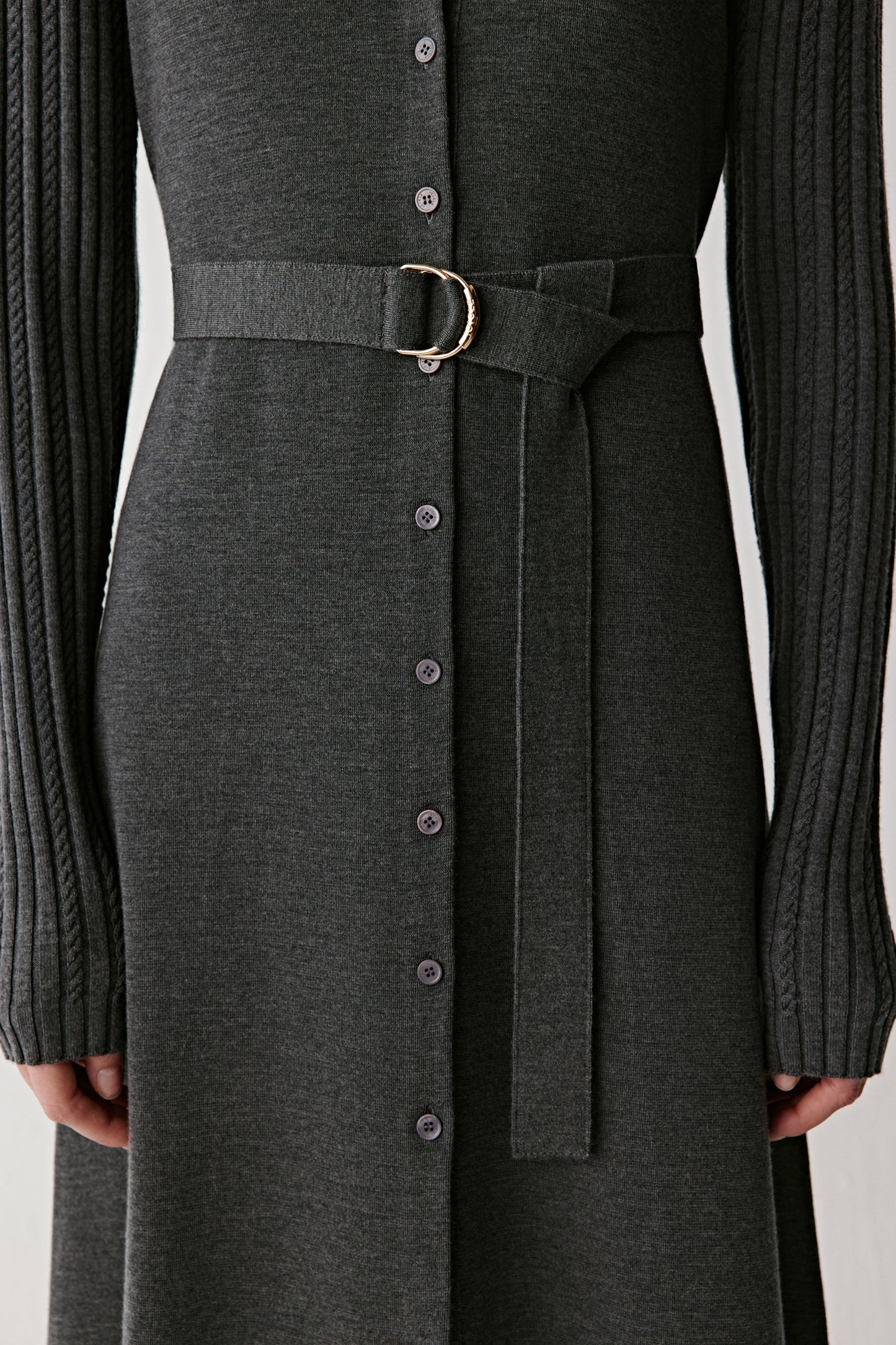 Close-up of the belted waist and buttons running down the front.