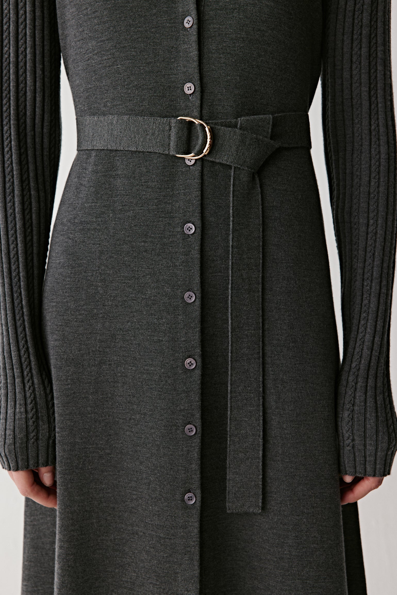 Close-up of the belted waist and buttons running down the front.