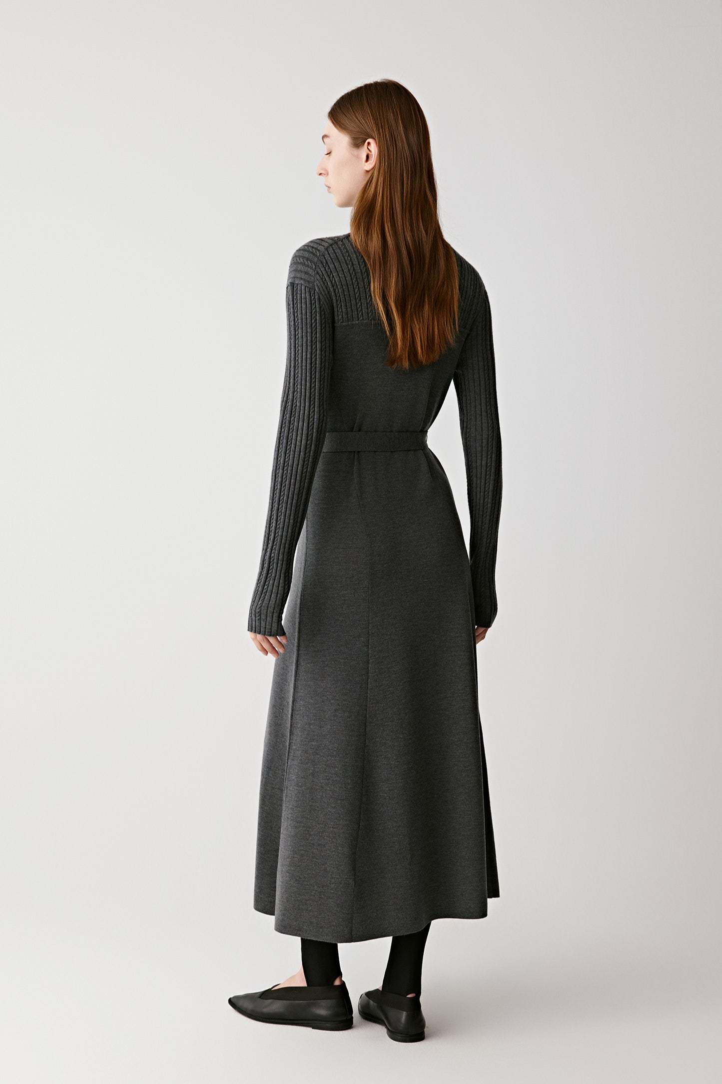 Back view of the dress showing the fluid drape and midi-length hem.