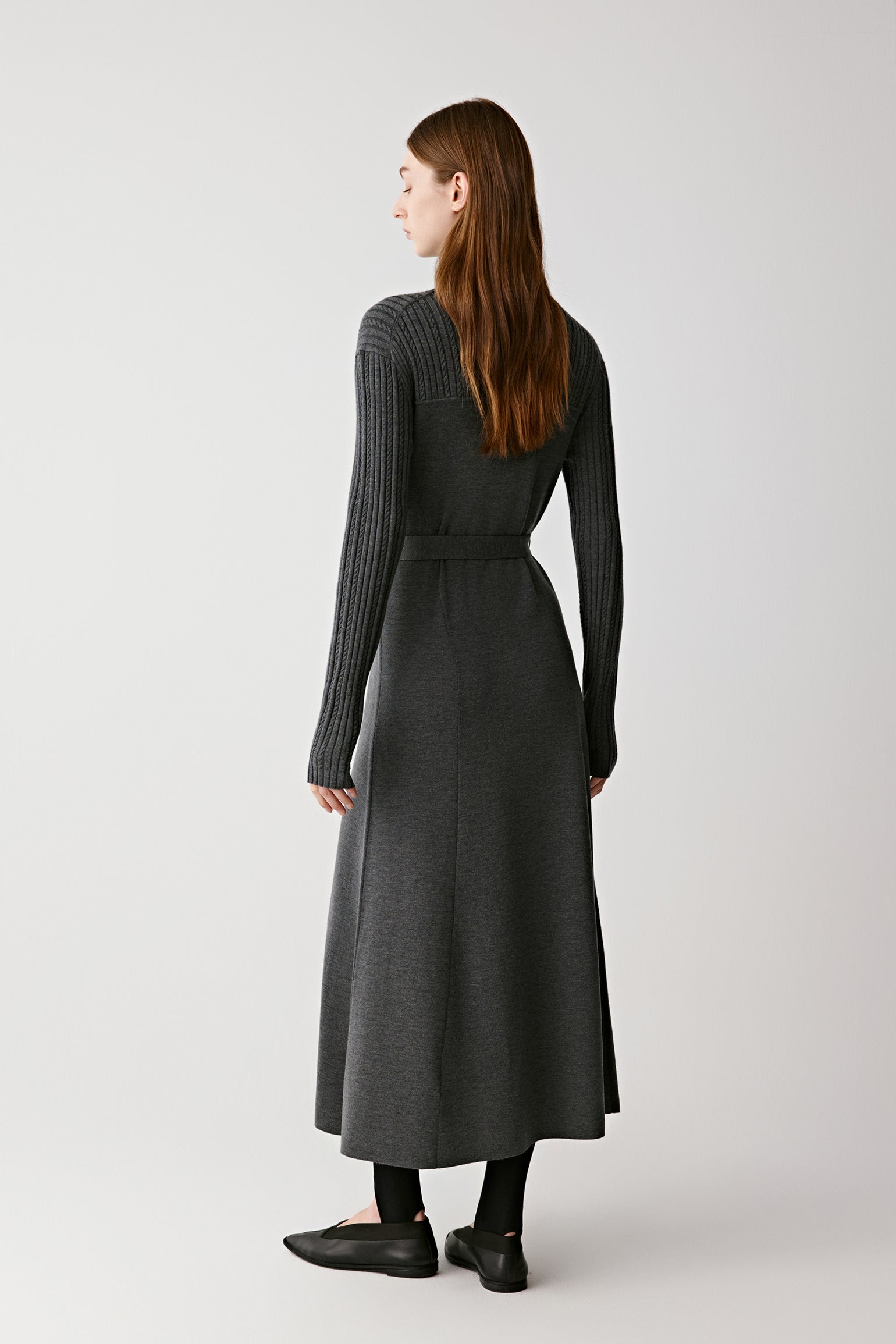 Back view of the dress showing the fluid drape and midi-length hem.