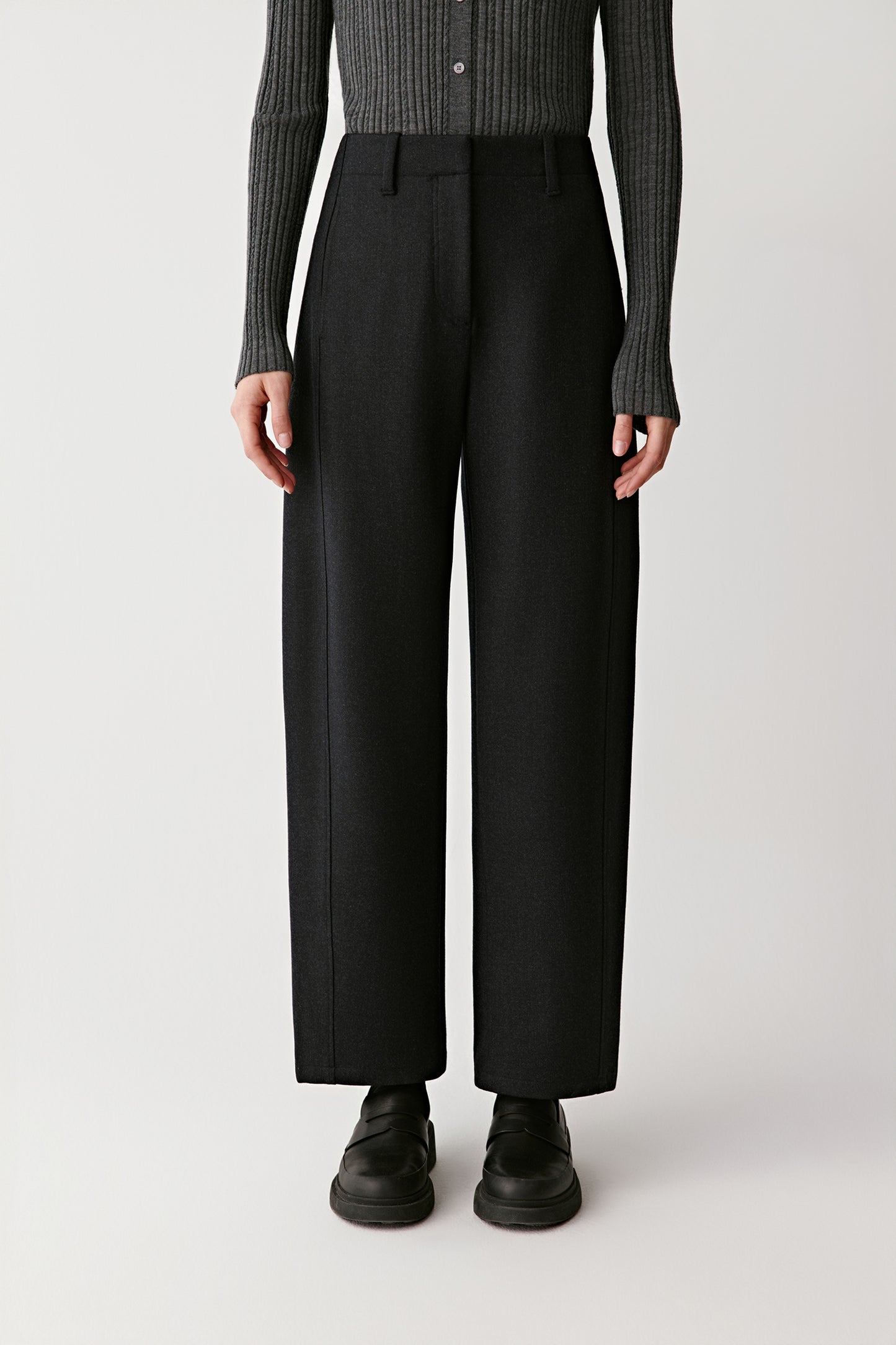 Full-length back view showing the tailored lines and pressed crease of the trousers.