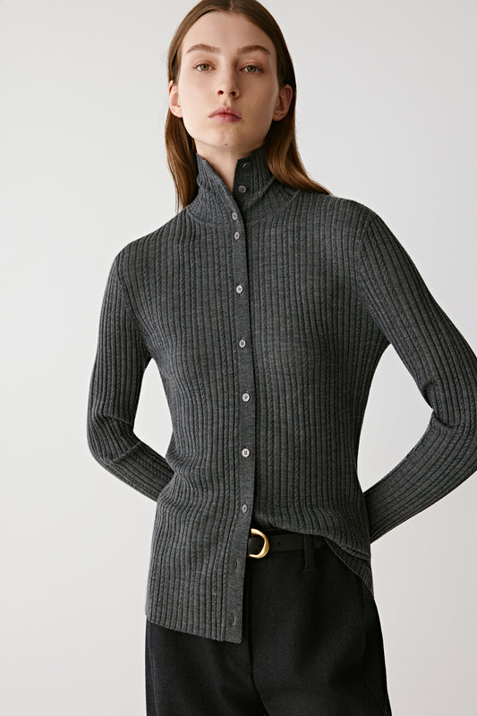 Three-quarter view highlighting the slim fit and vertical rib knit structure.