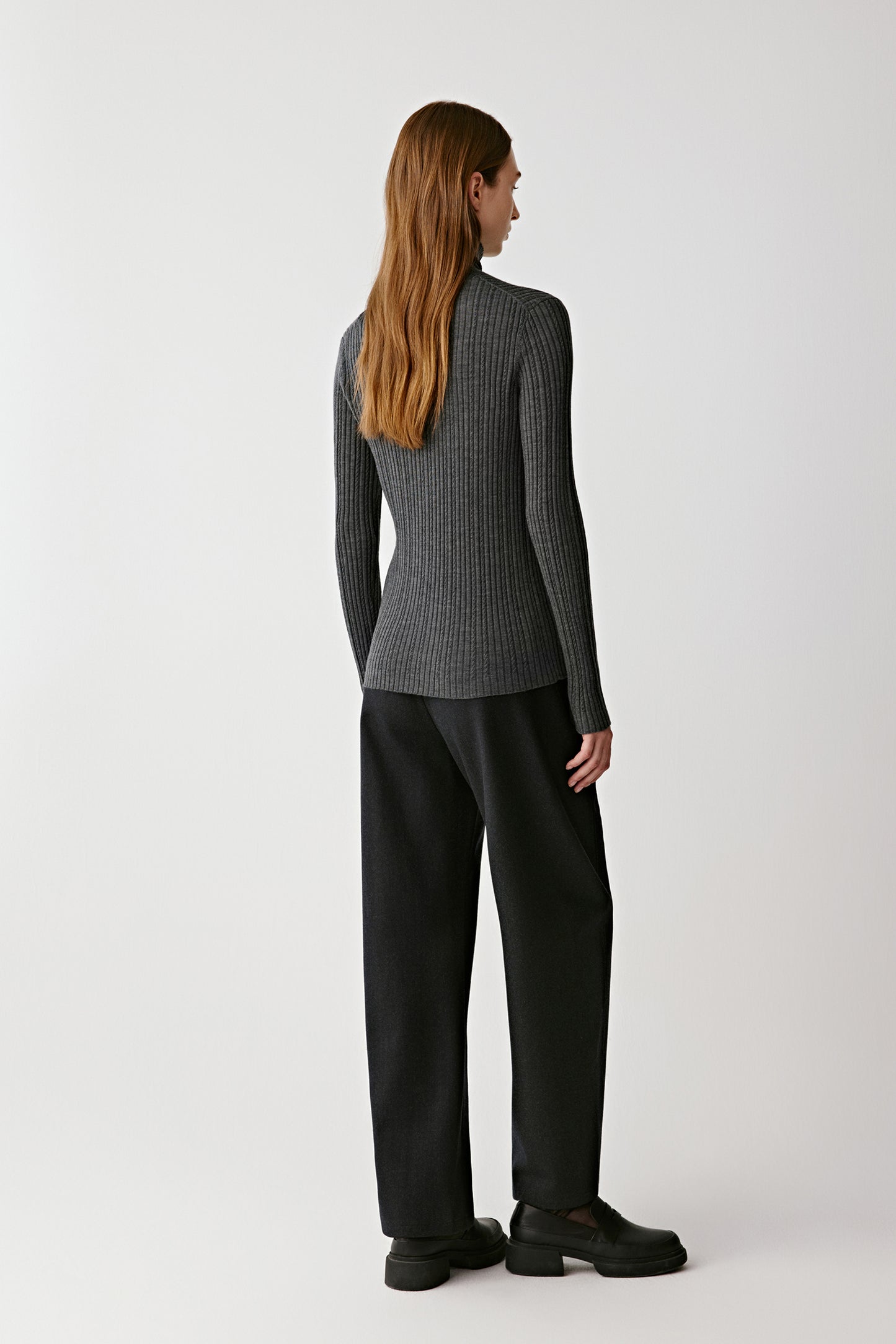Back view revealing the cardigan’s fitted shape and clean finishing.