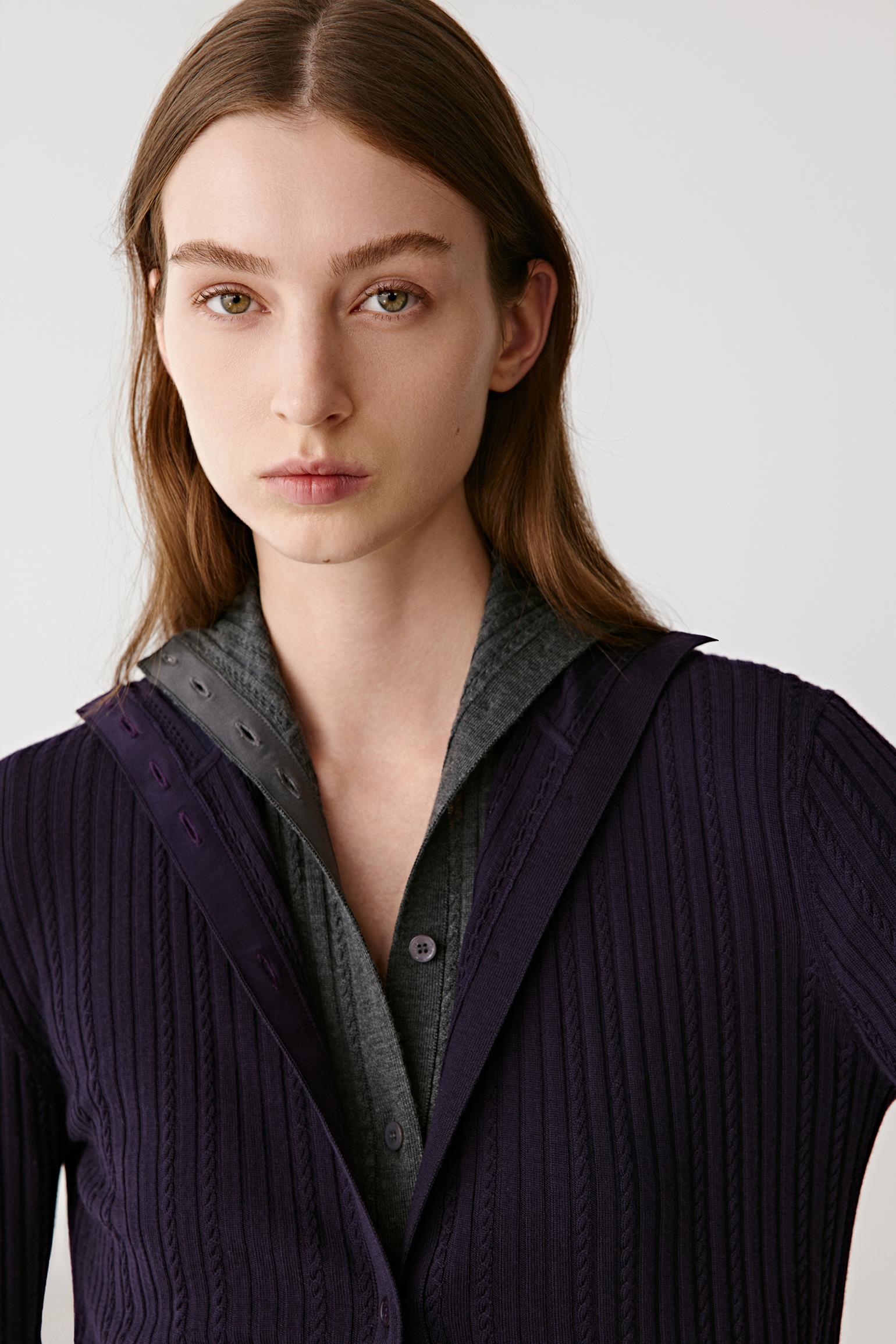 Three-quarter front view showing the open front and tailored sleeves.