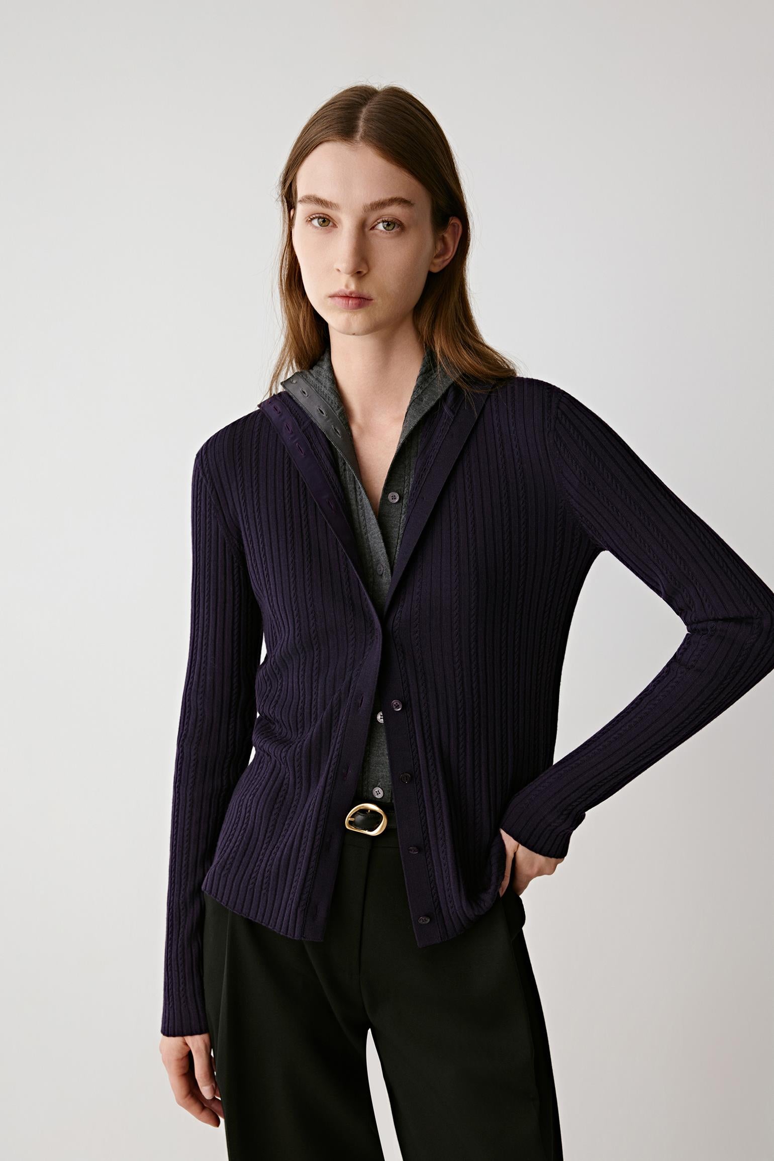 Front view of a model wearing a purple wool cardigan with a soft shawl collar and fluid drape.Front view of a model wearing a purple wool cardigan with a soft shawl collar and fluid drape.