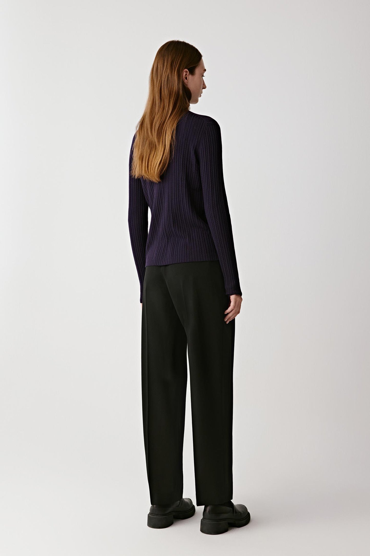 Back view of the cardigan showing its relaxed cut and elegant fall.