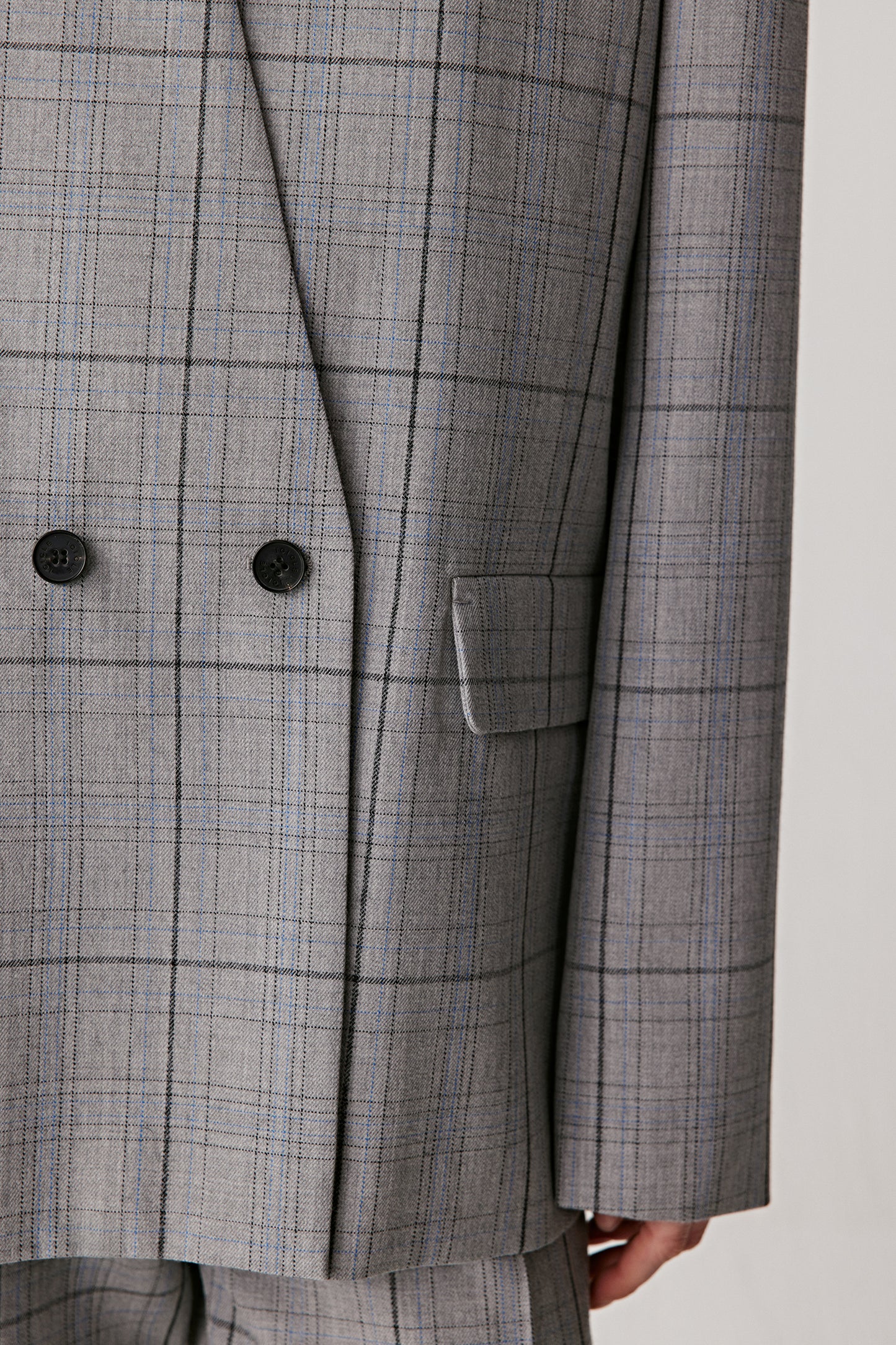 Details of a checkered blazer on a white background