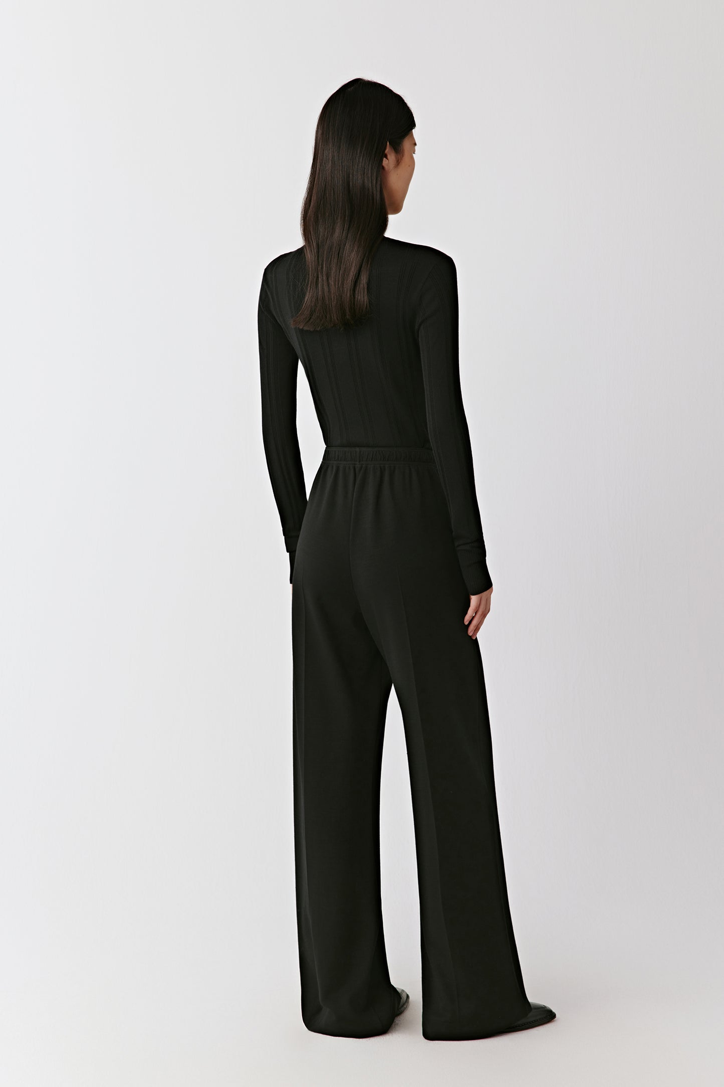 A rear view highlights the straight line of the cut and smooth elasticated waistband.