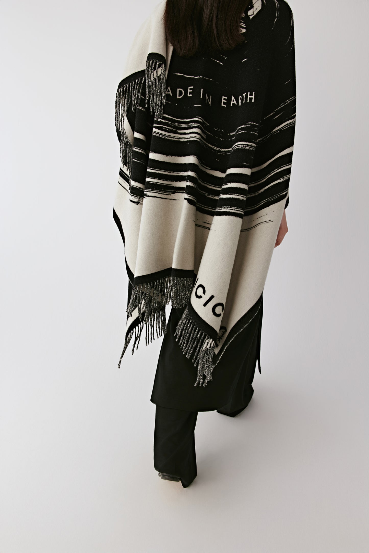 Rear view showing the large-scale pattern and supple structure of the shawl.