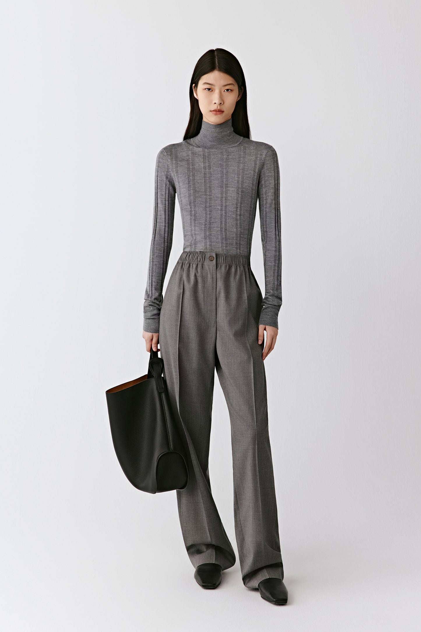 A front view shows the close fit and fluid stretch of the ribbed knit.