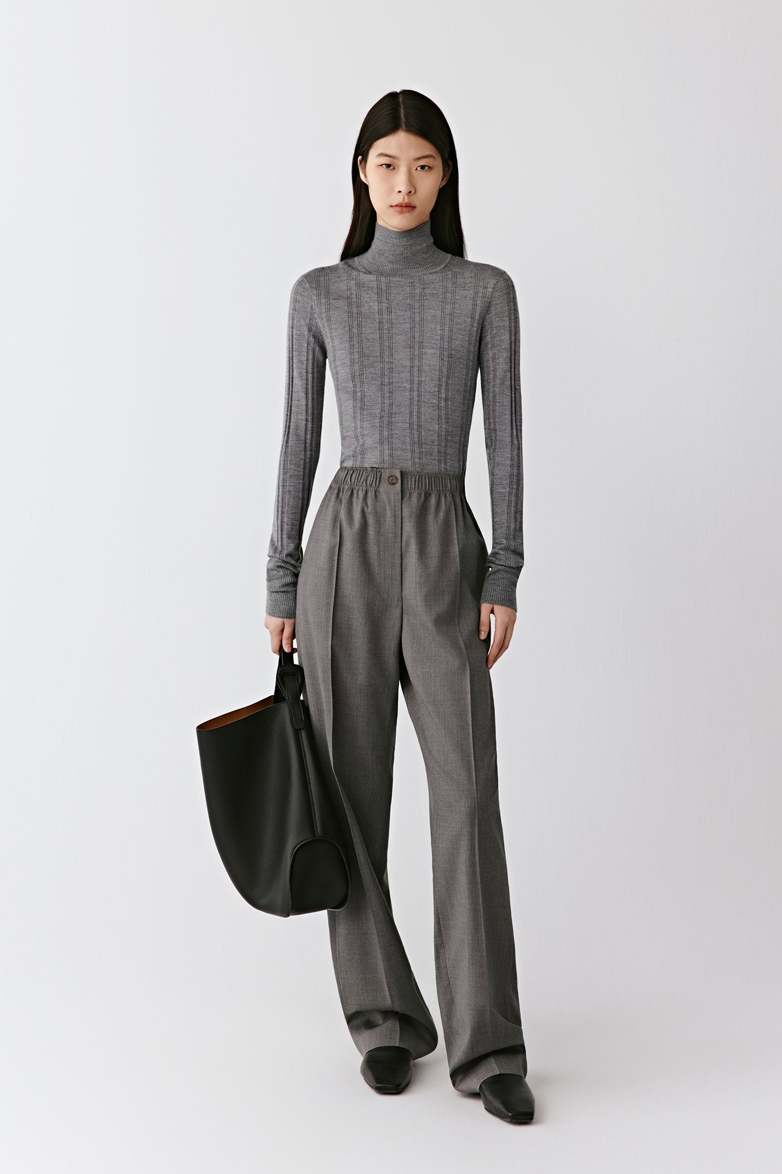 A front view shows the close fit and fluid stretch of the ribbed knit.