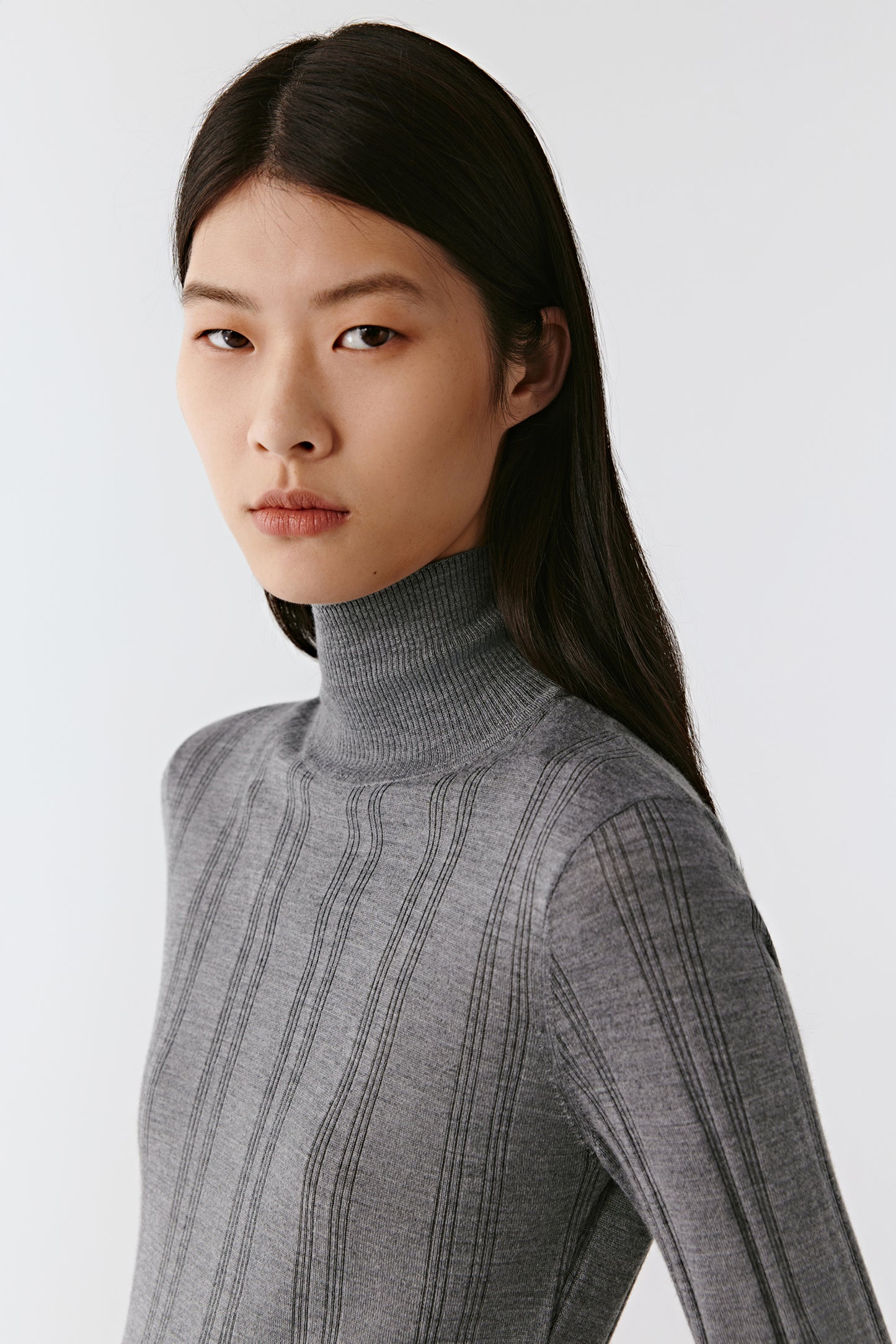 A mid-shot focuses on the collar and shoulder line under soft light.