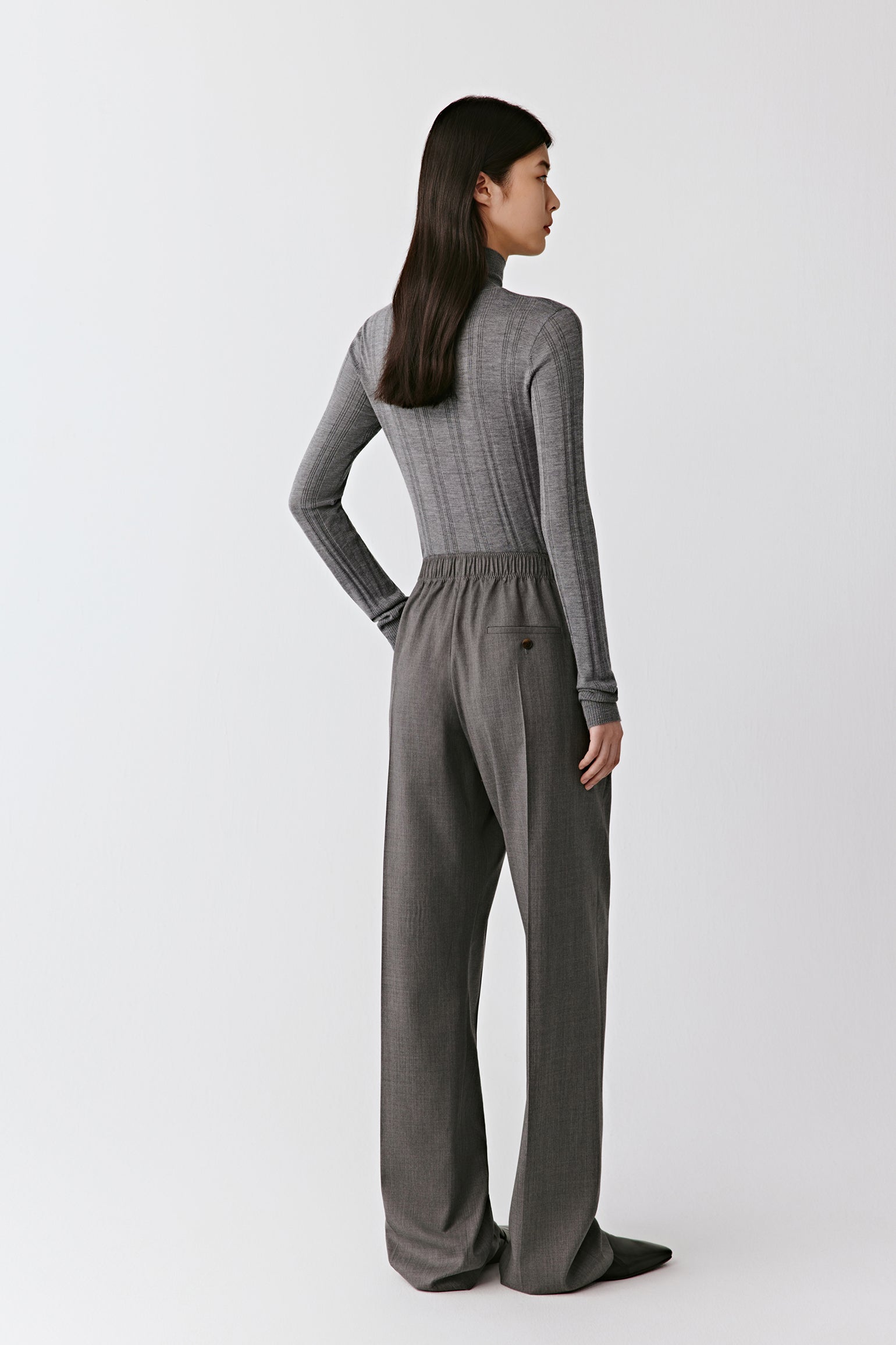 A rear view captures the vertical lines and smooth silhouette.