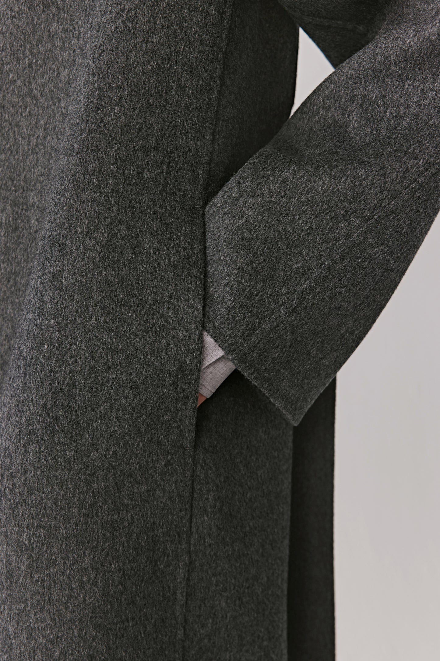 Close-up of the sleeve and pocket detail showing the coat’s fine craftsmanship.