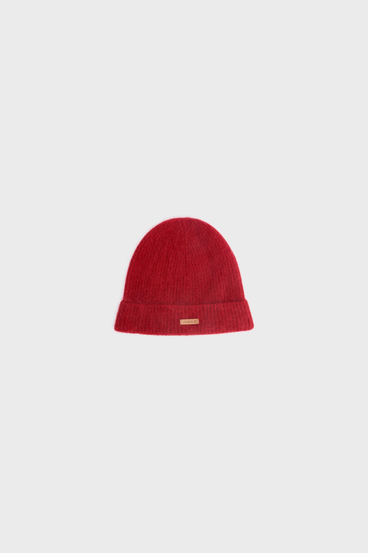 Studio shot of the red cashmere beanie, showing its rounded silhouette and ribbed knit texture.