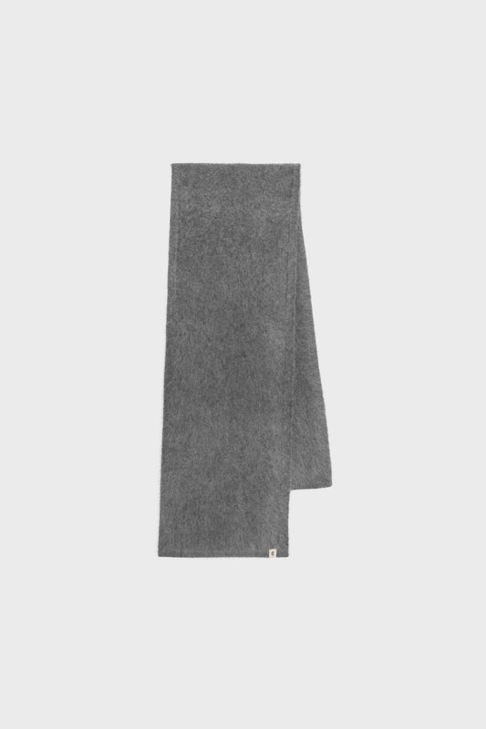 Flat-lay view of the grey cashmere scarf, showing its minimalist rectangular form and refined neutral tone.
