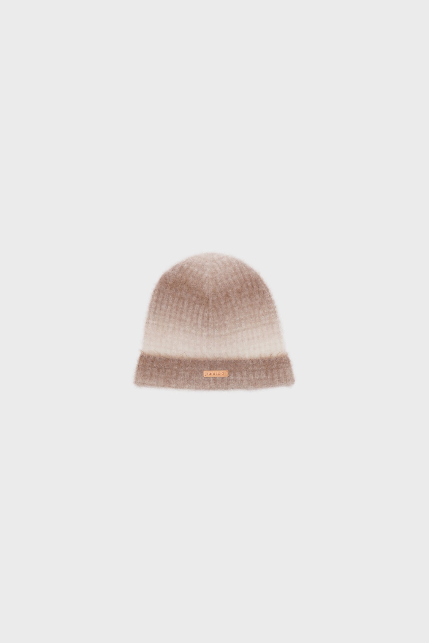 Front view of a cashmere beanie with a soft gradient pattern in camel and light beige, displayed on a neutral background.