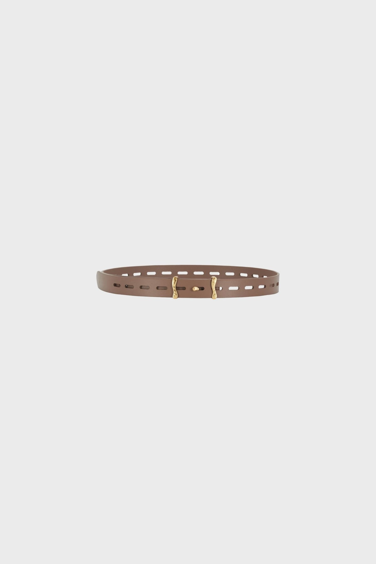 Flat lay product view of the slim brown calf leather belt placed horizontally, highlighting the even strap width, elongated perforations forming a regular linear rhythm, smooth surface with a lightly structured finish, clean edge painting and sculptural antique gold-tone brass buckle
