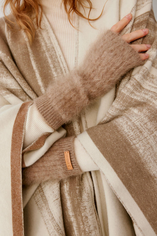 Close-up of natural taupe brushed cashmere fingerless gloves, showing the elongated ribbed construction and open fingers.