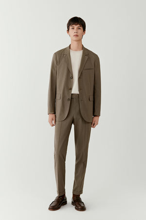 Man wearing a khaki check silk and wool blazer with straight tailored fit, styled with matching khaki trousers and white T-shirt, full-length front view.