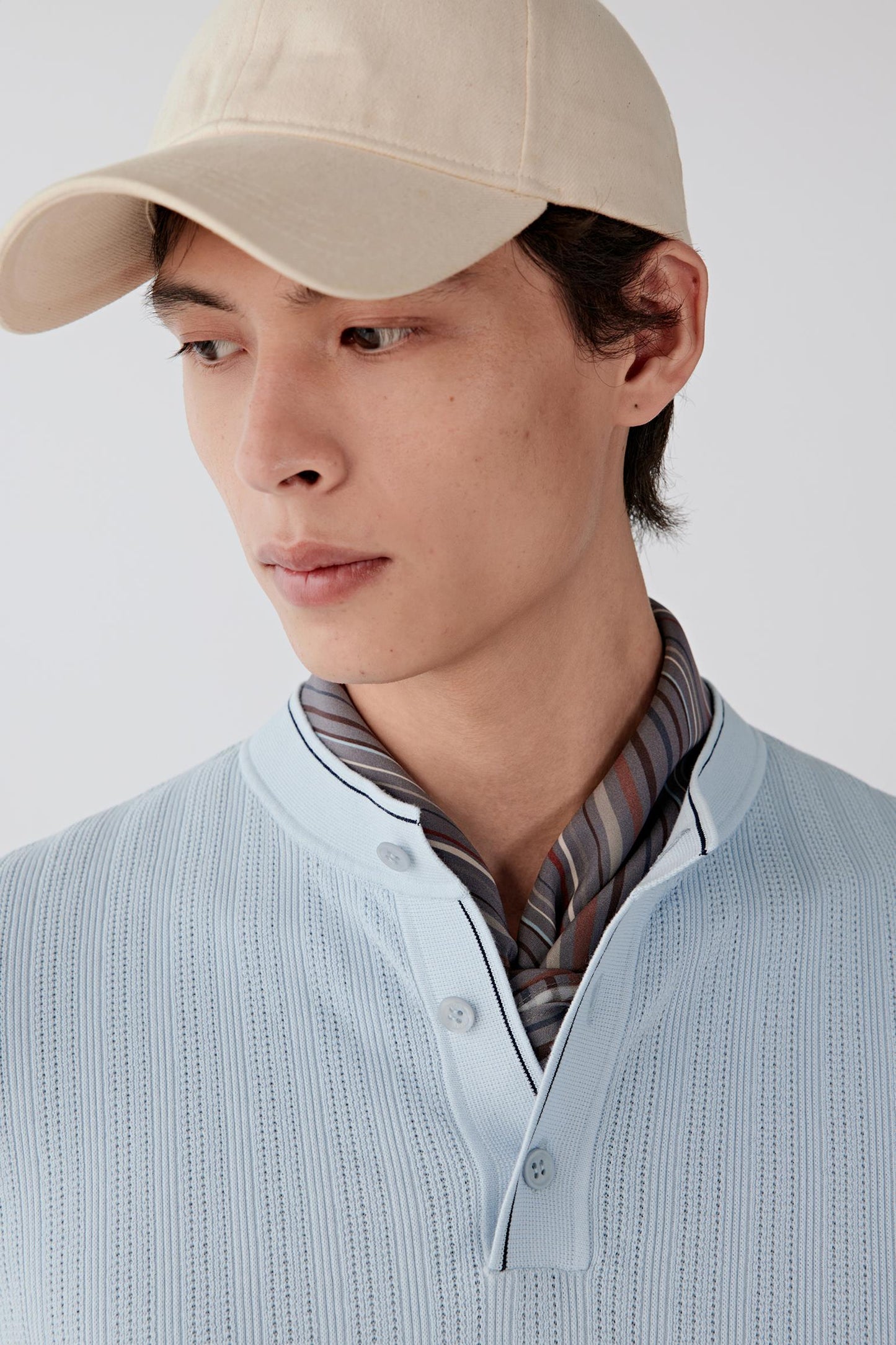 Close-up of the neckline and buttons, showing refined detailing and neat construction.