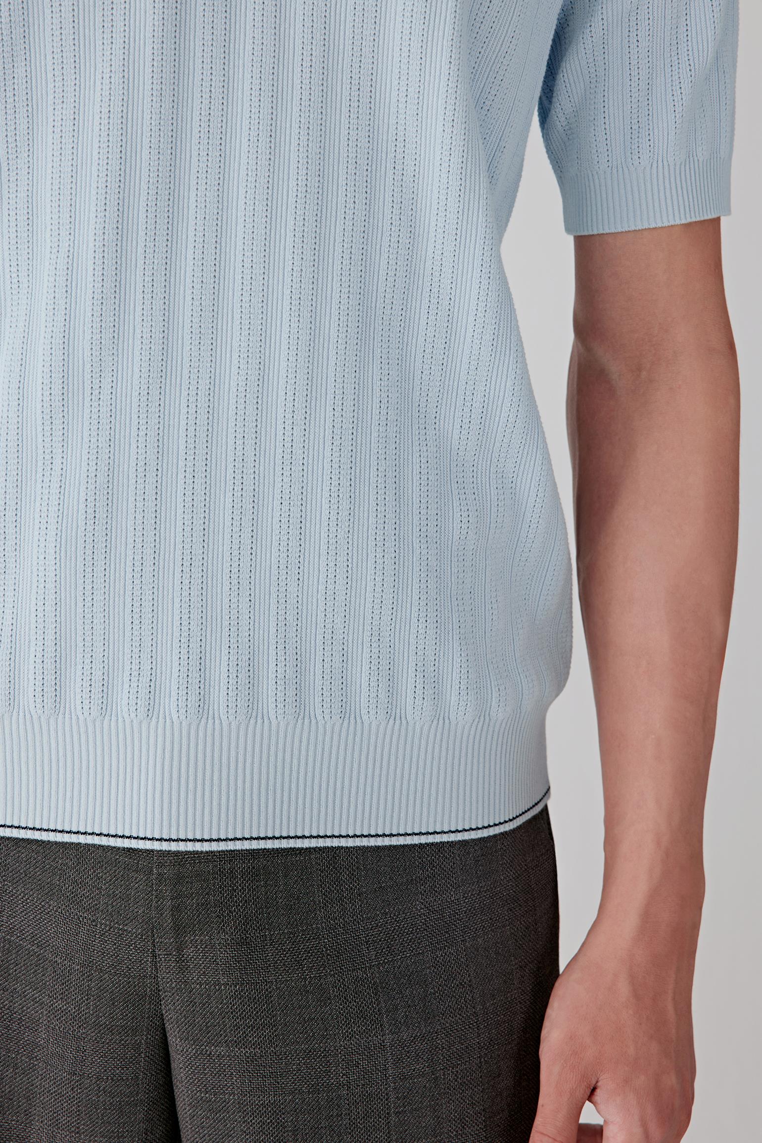 Fabric detail revealing the fine vertical knit texture of the cotton yarn.