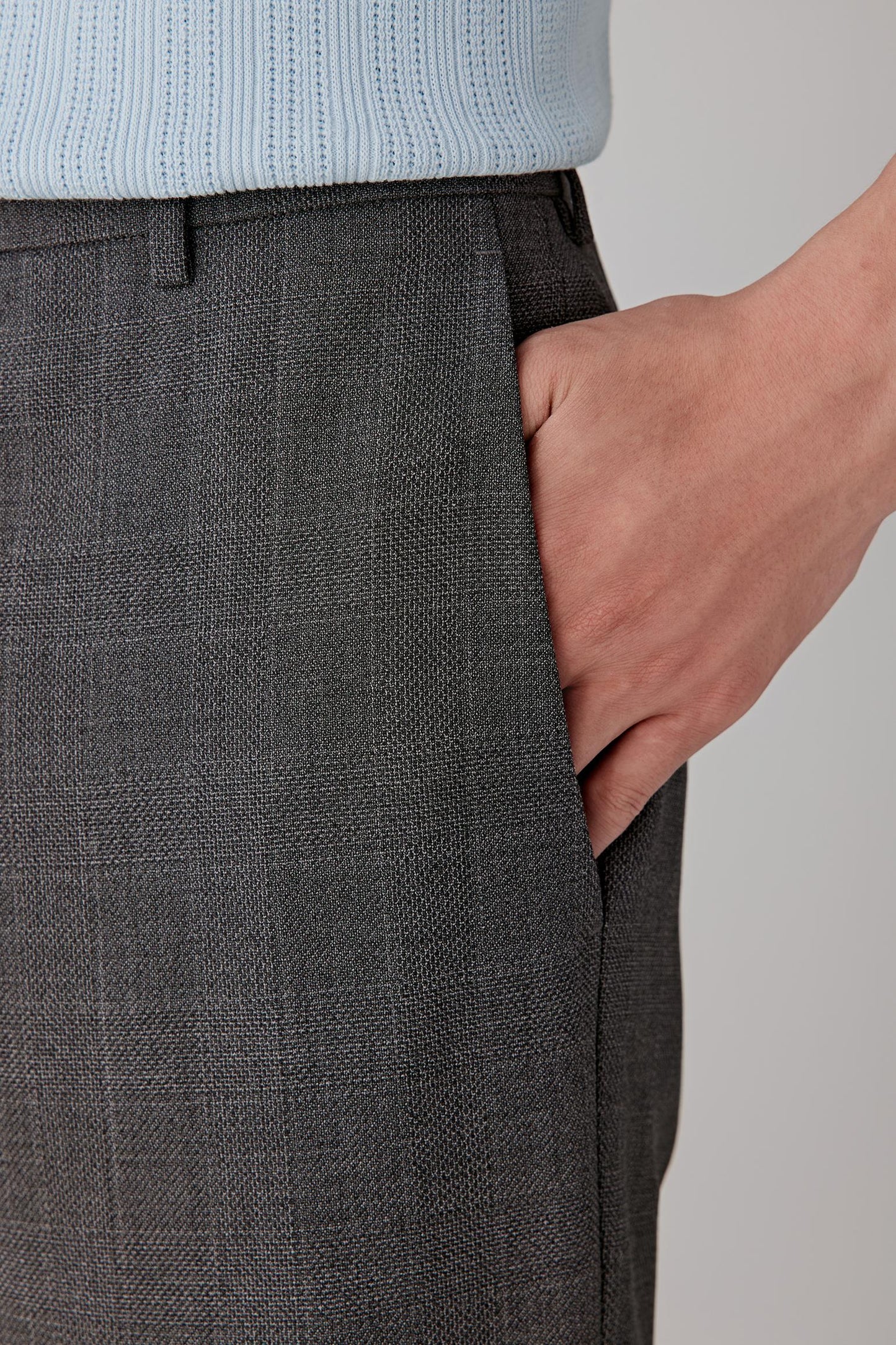 Close-up of the side pocket and fabric texture in dark grey twill.