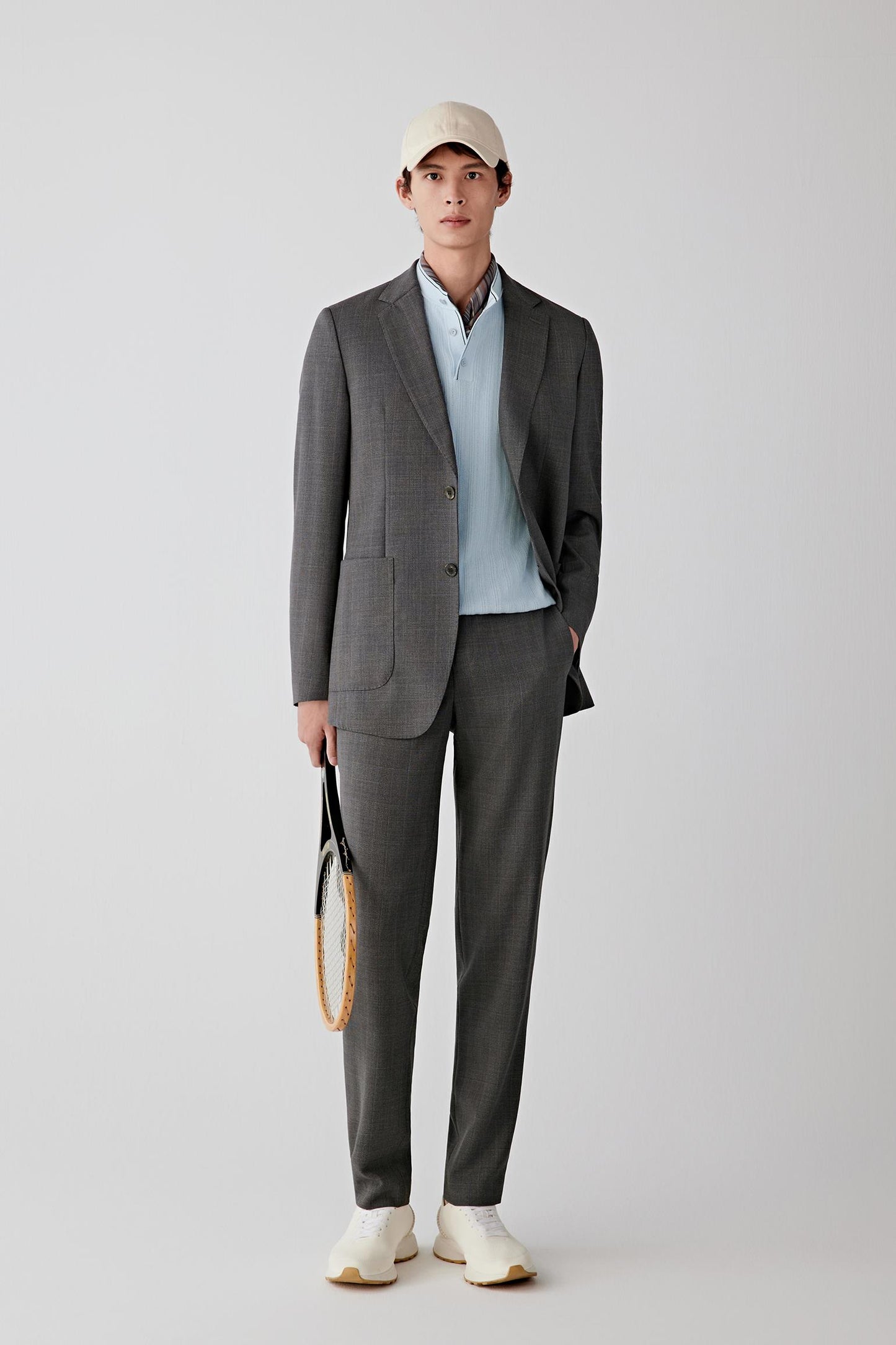 Man wearing a dark grey check wool jacket with matching trousers, full-length front view.