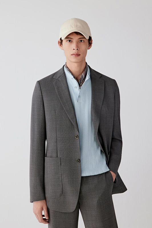 Three-quarter view highlighting the notched lapel and button fastening.