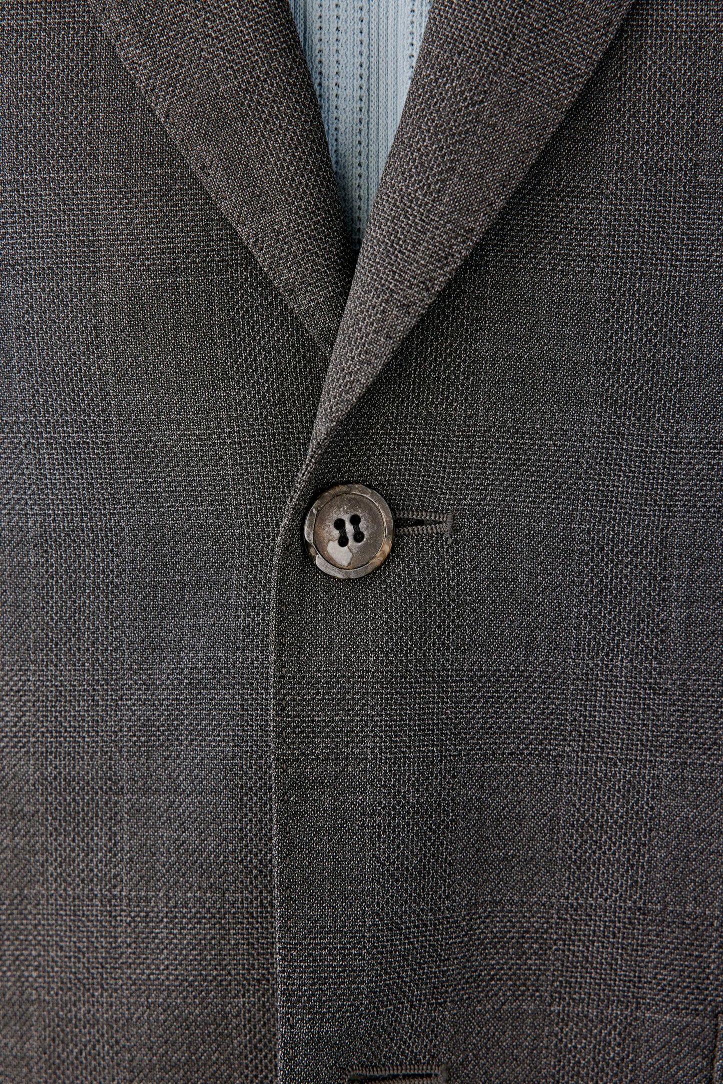 Close-up of the lapel and front button detail.