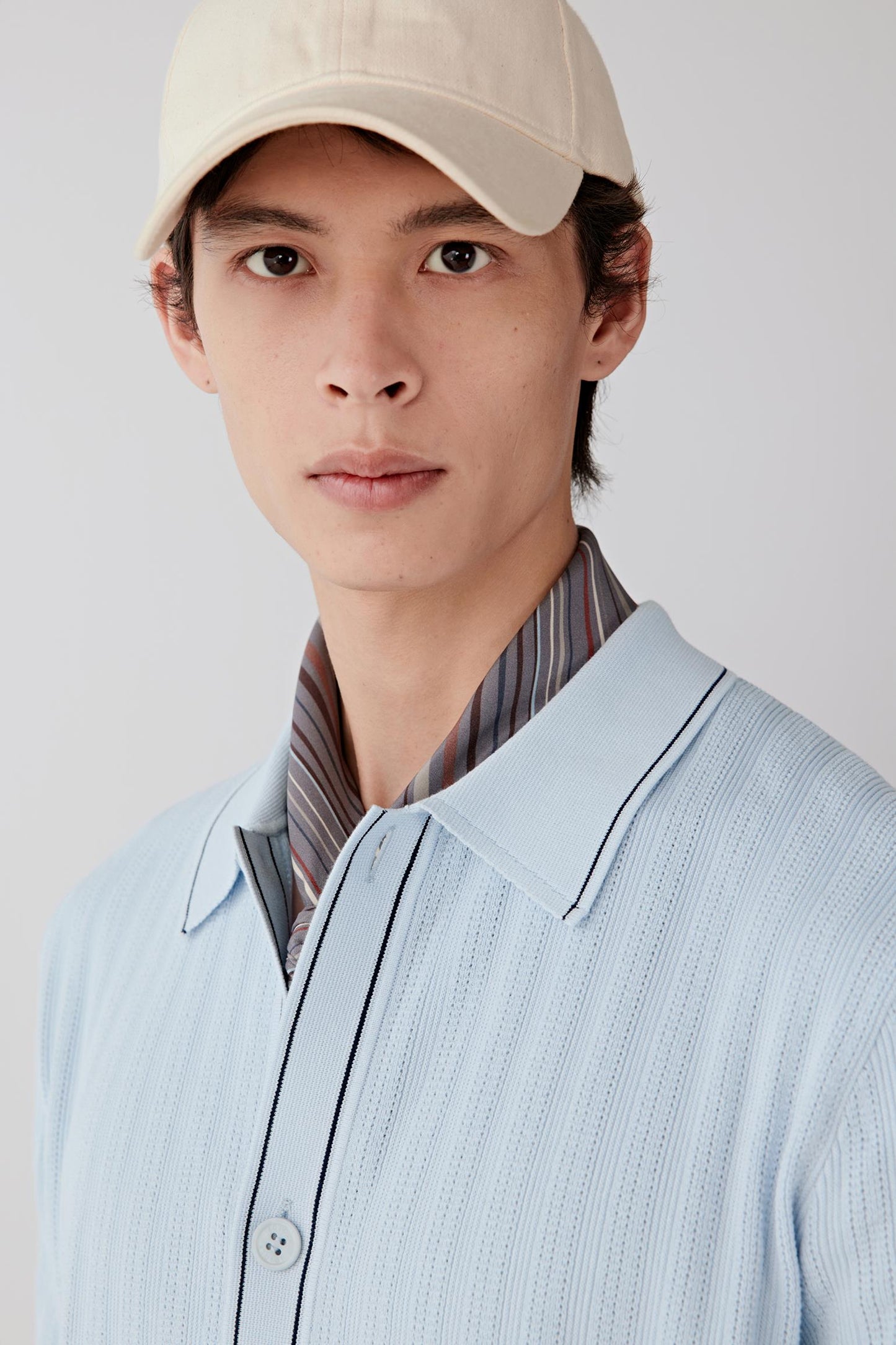 Close-up of the collar and button placket, showing precise finishing and contrast detail.