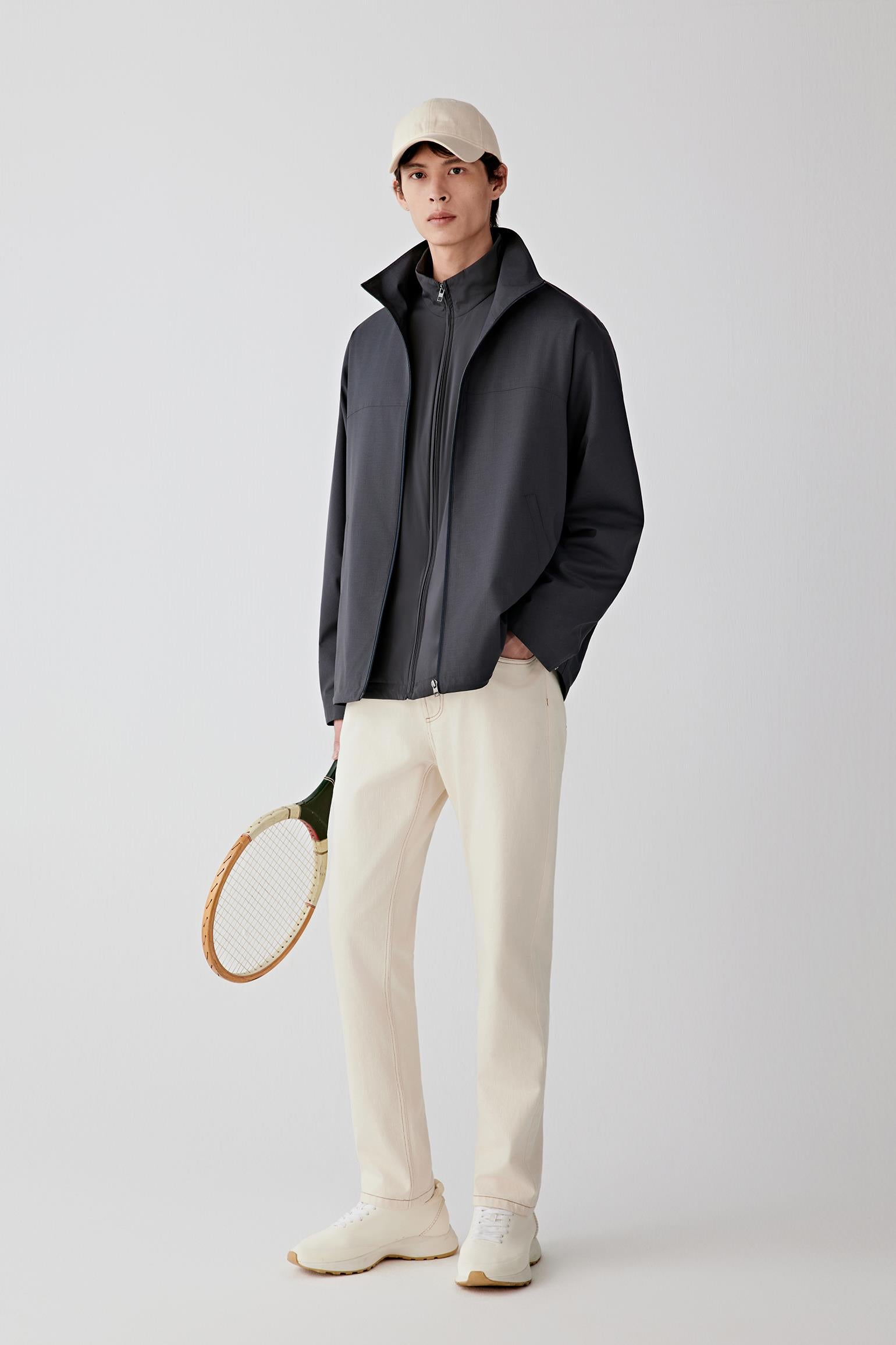 Full-length front view of a zip-front jacket in worsted wool and silk in dark grey, with a stand collar.