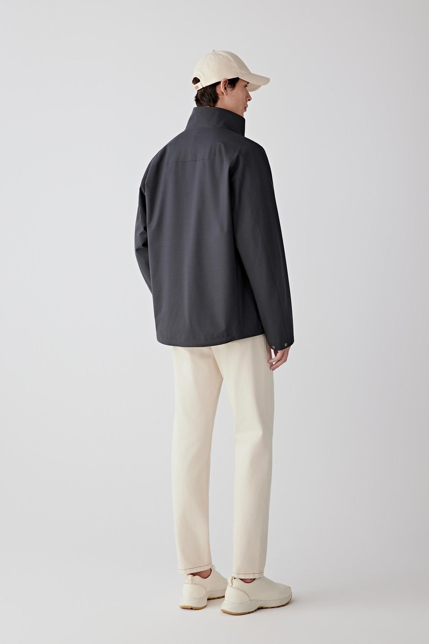 Back view of the jacket, emphasizing its straight, functional silhouette.
