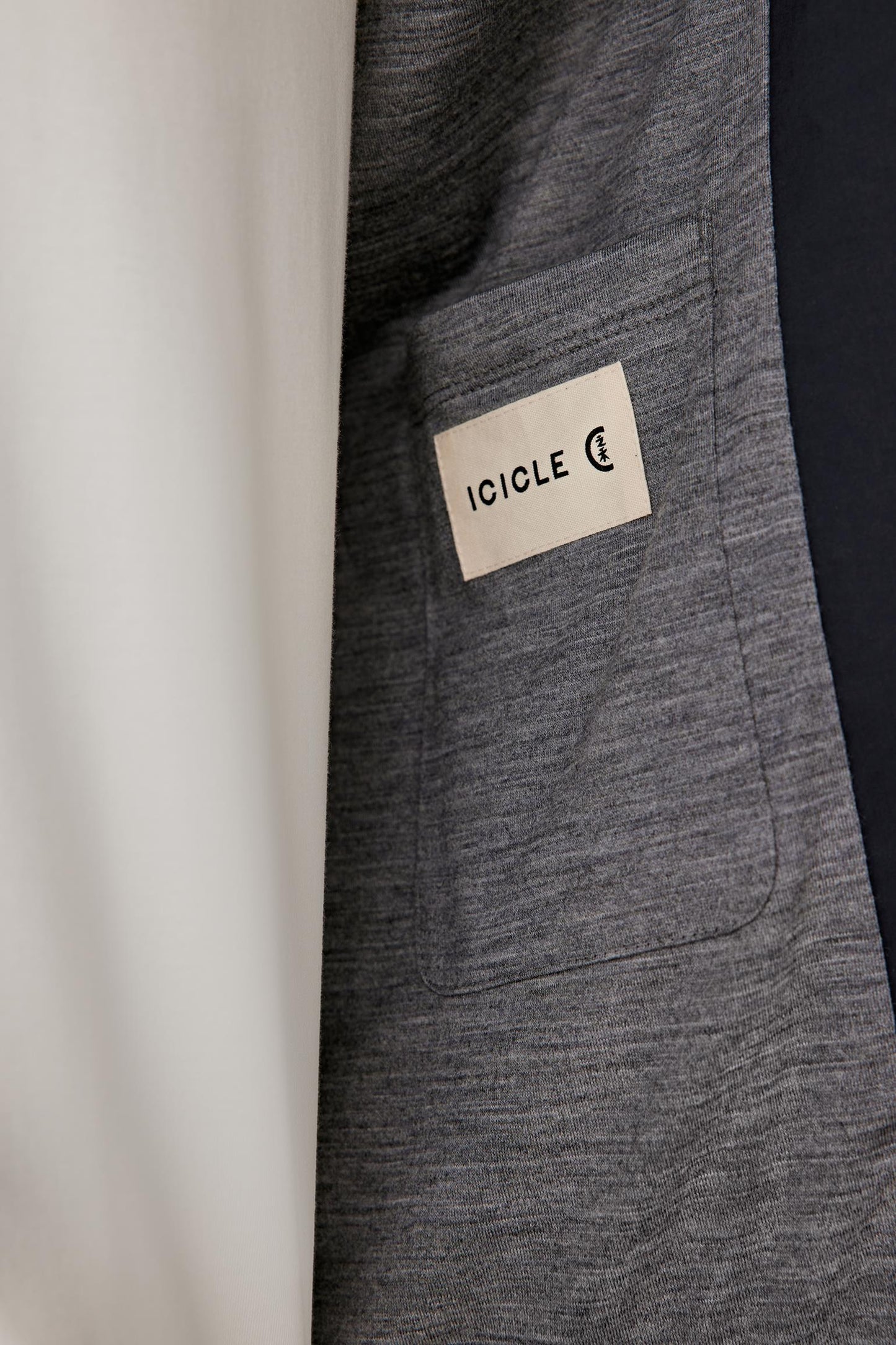 Detail view of the pocket and fabric, highlighting the smooth poplin weave.