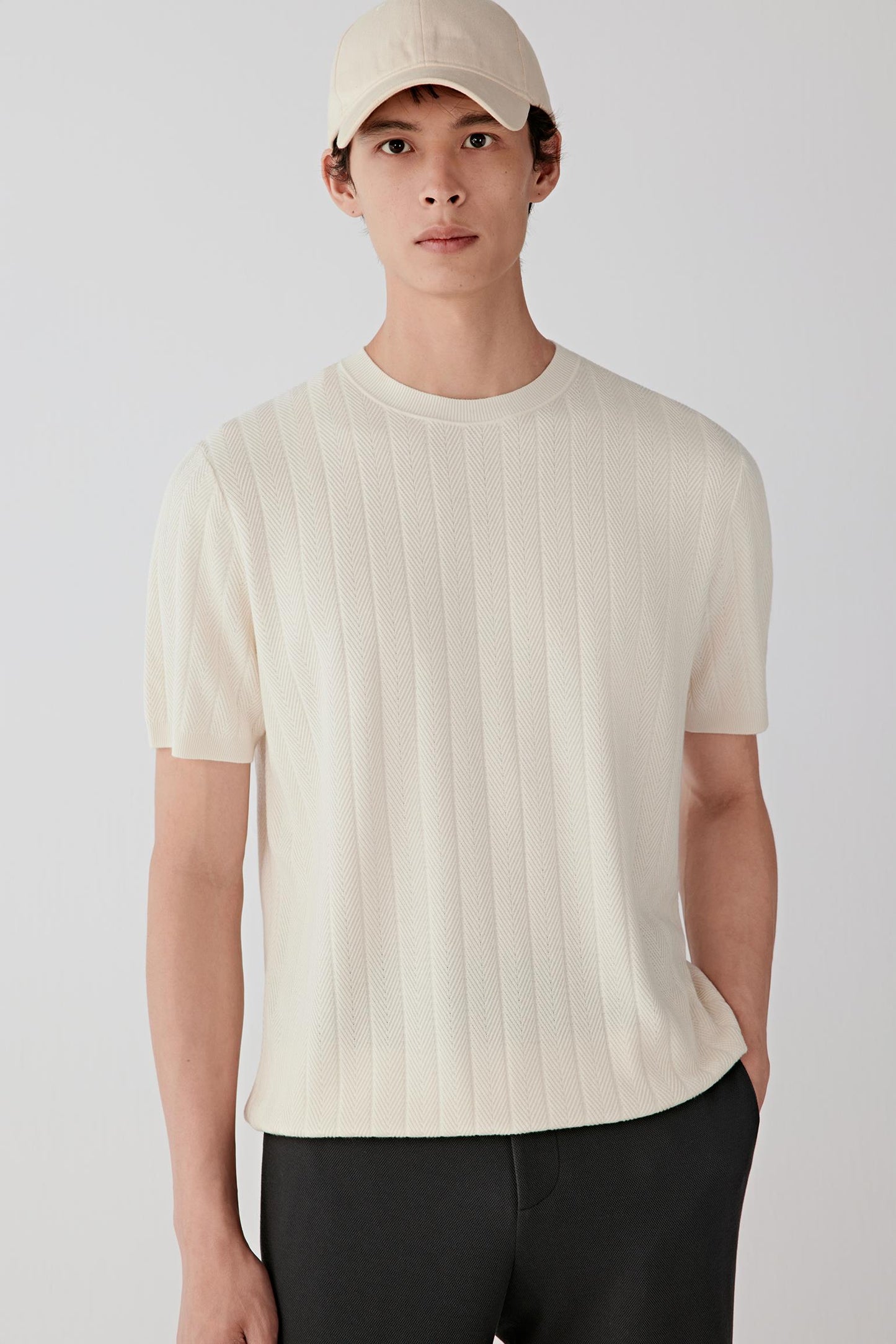 Front view of a white silk-yarn pullover with short sleeves and a softly structured silhouette.