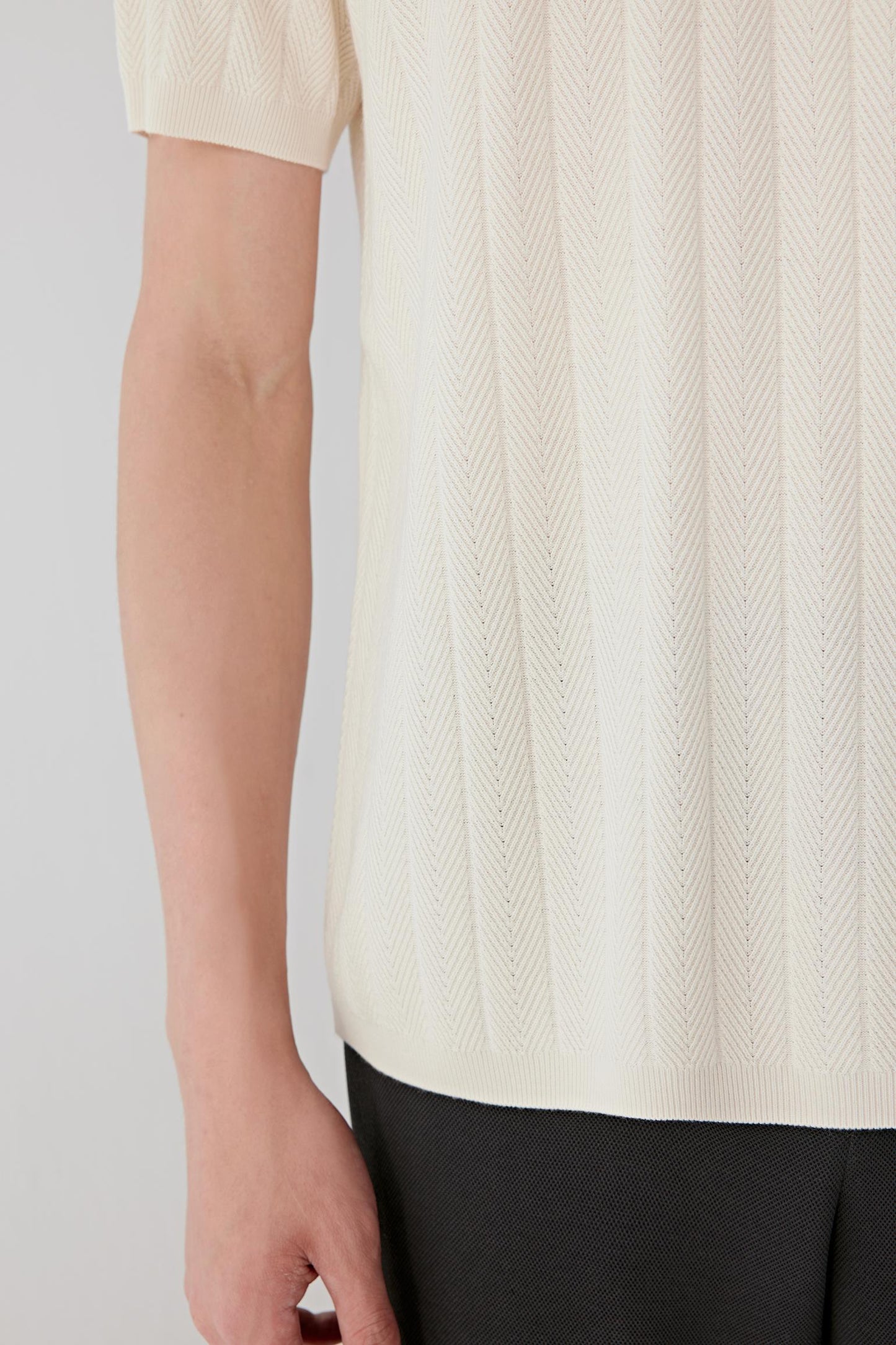 Fabric detail revealing the subtle vertical texture of the silk knit.