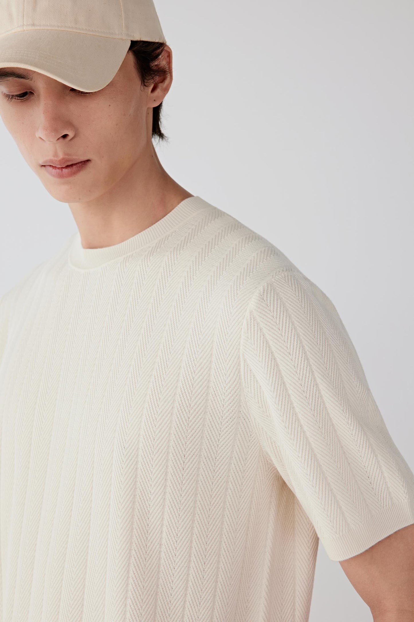 Close-up of the neckline, showing fine rib detailing and clean finishing.