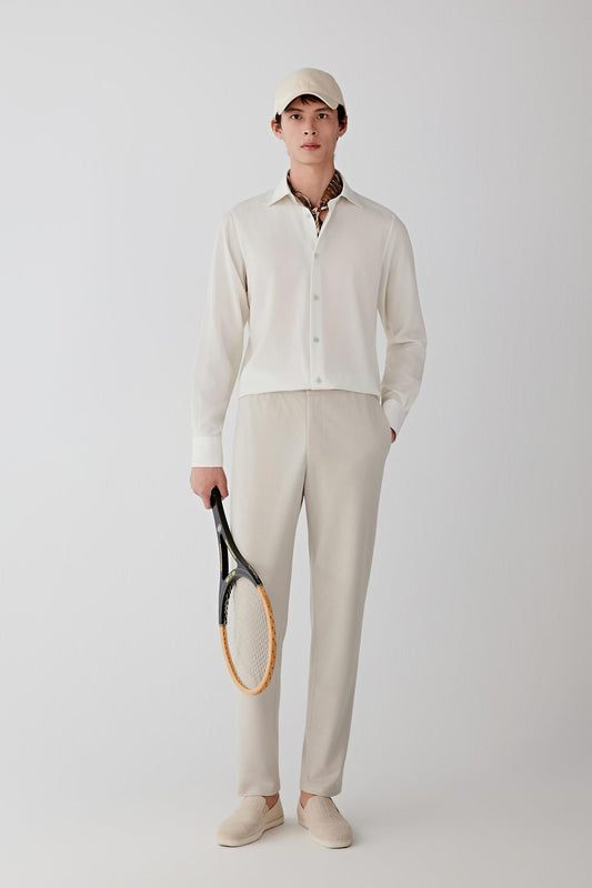 Full-length front view of beige Ponte de Roma wool trousers worn with a matching top, showing a clean, relaxed silhouette and straight-leg cut.