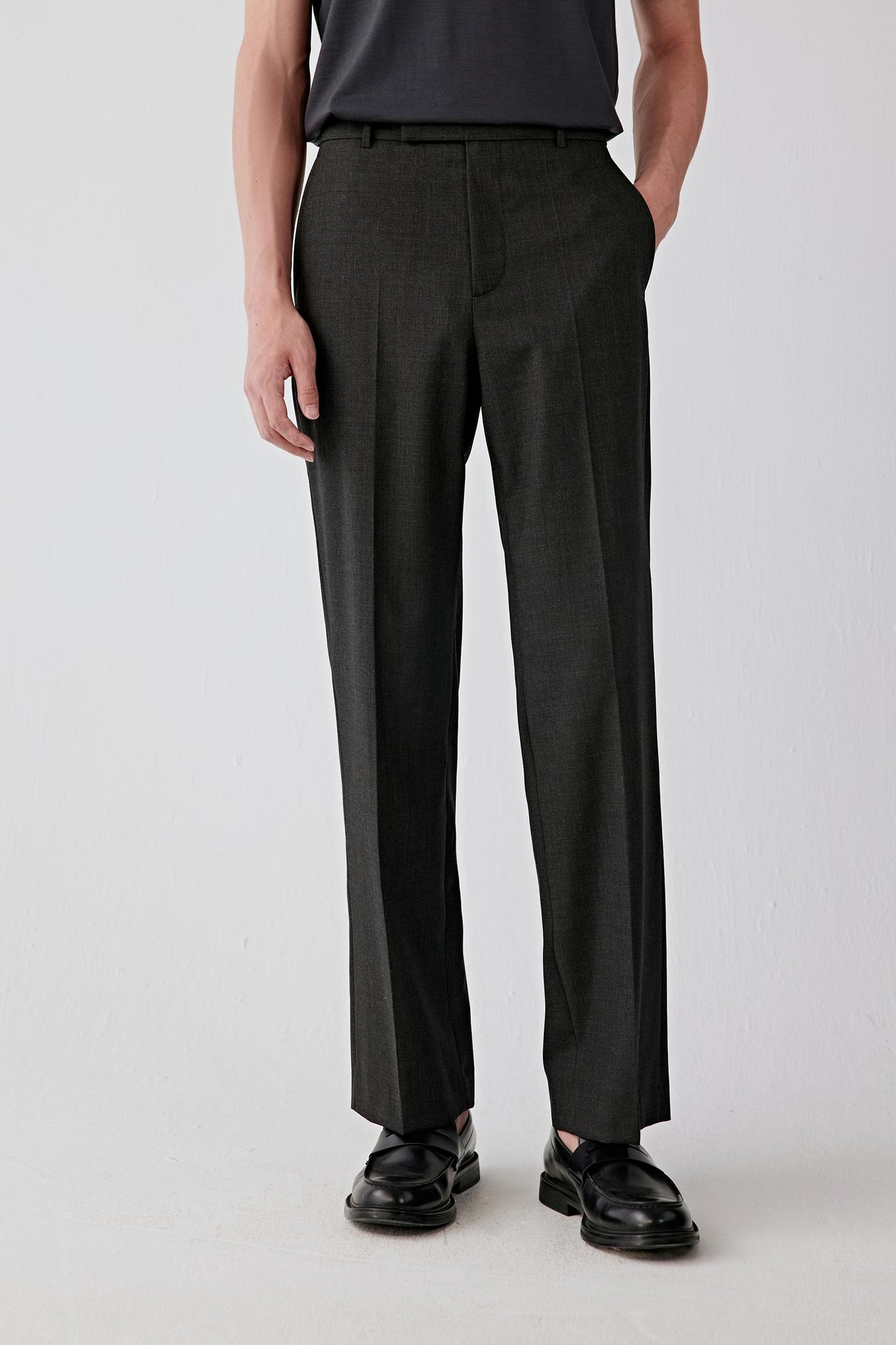 Front view focused from waist to shoes, highlighting the straight-leg cut and smooth fall of the twist wool fabric.