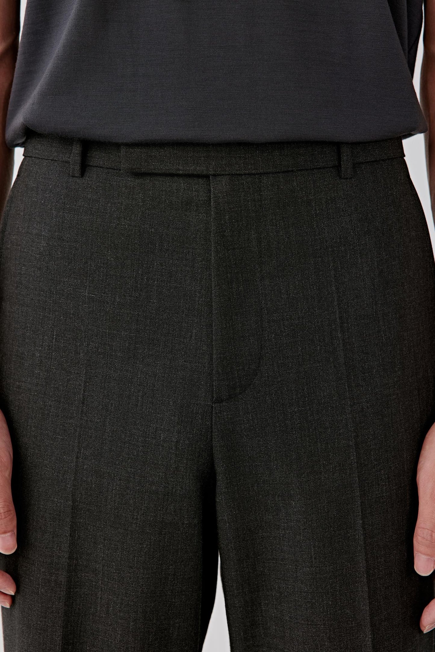 Close-up of the upper leg and hip area, revealing the fine texture of the twist wool and subtle crease line.