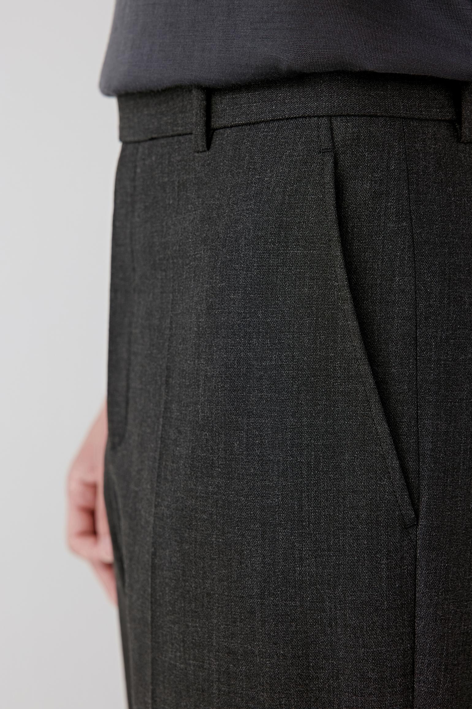 Close-up of the upper leg and hip area, revealing the fine texture of the twist wool and subtle crease line.