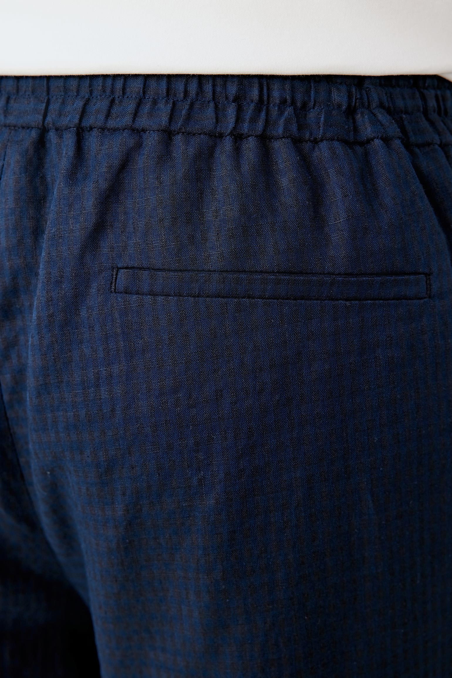Close-up of the waistband construction detailing the elasticated finish, gathered structure and drawstring fastening. The woven linen and cotton blend reveals a lightly textured surface with subtle tonal variation.