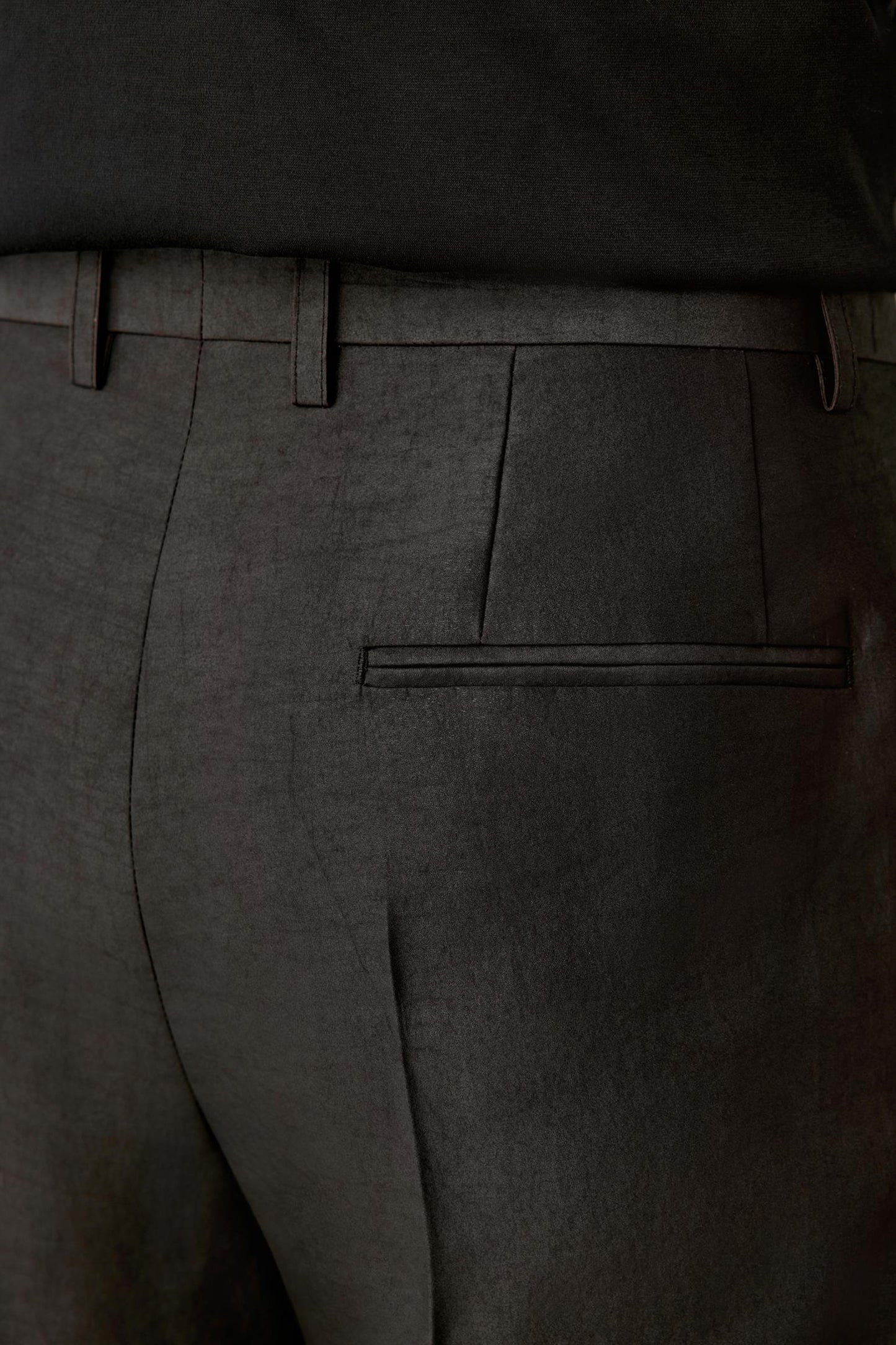 Back detail focusing on the rear pocket and seam finishing, with the fabric’s natural sheen and artisanal irregularities visible.