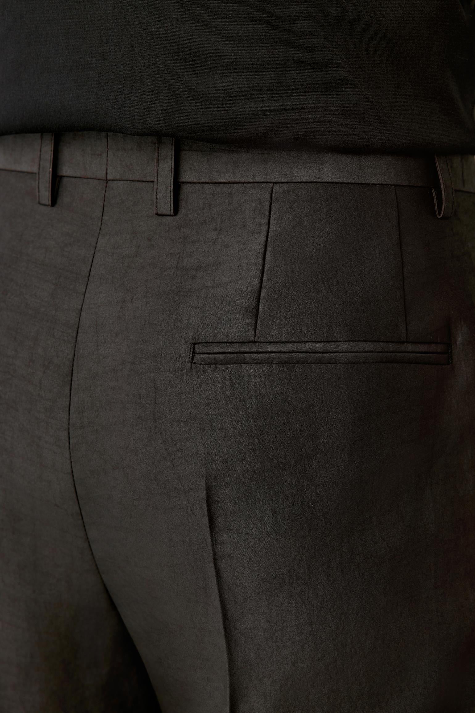 Back detail focusing on the rear pocket and seam finishing, with the fabric’s natural sheen and artisanal irregularities visible.