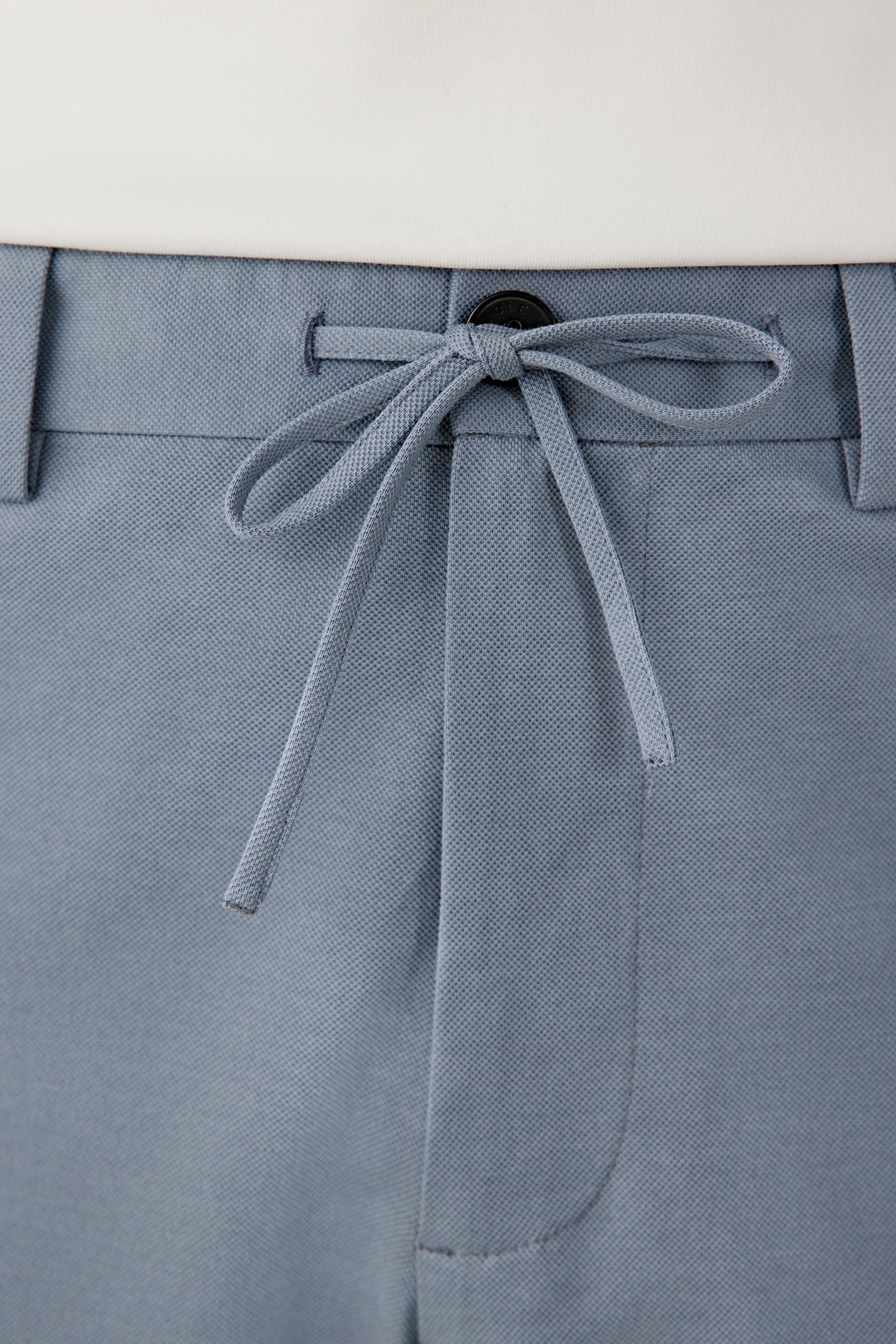 Close-up of the waistband detailing the drawstring fastening, gathered elasticated construction and textured piqué surface. The image highlights the soft hand and tonal depth of the stone blue shade.